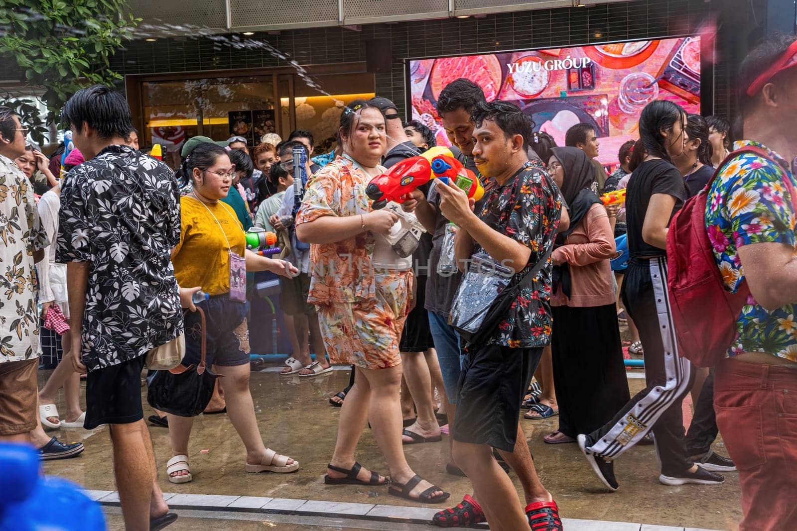 Siam Square, Bangkok, Thailand - APR 13, 2024 Songkran Festival, The short action of people joins celebrations of the Thai New Year or Songkran in Siam Square Bangkok, Thailand.