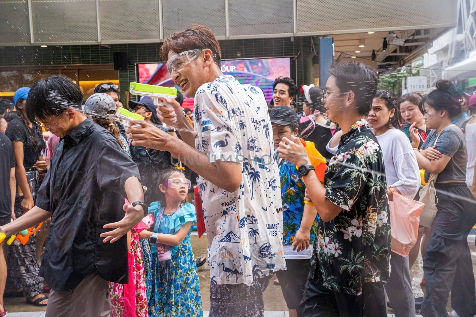 Siam Square, Bangkok, Thailand - APR 13, 2024 Songkran Festival, The short action of people joins celebrations of the Thai New Year or Songkran in Siam Square Bangkok, Thailand.
