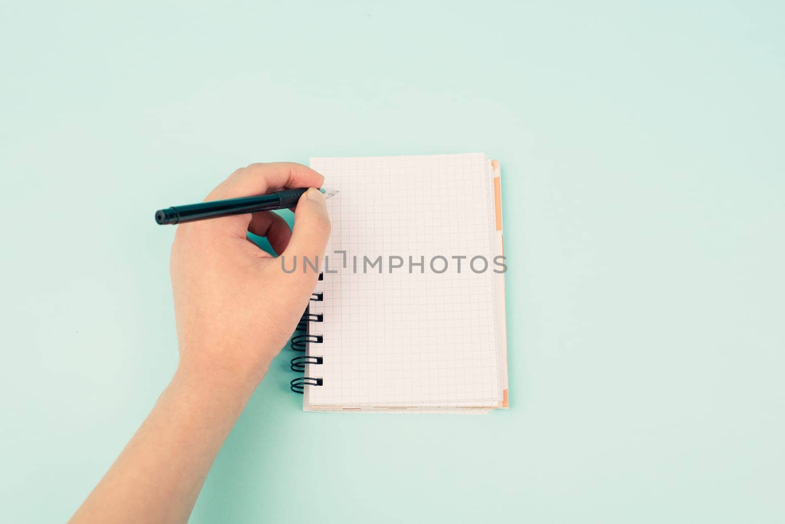 Left handers day, empty notebook, writing with the left hand, pen and table