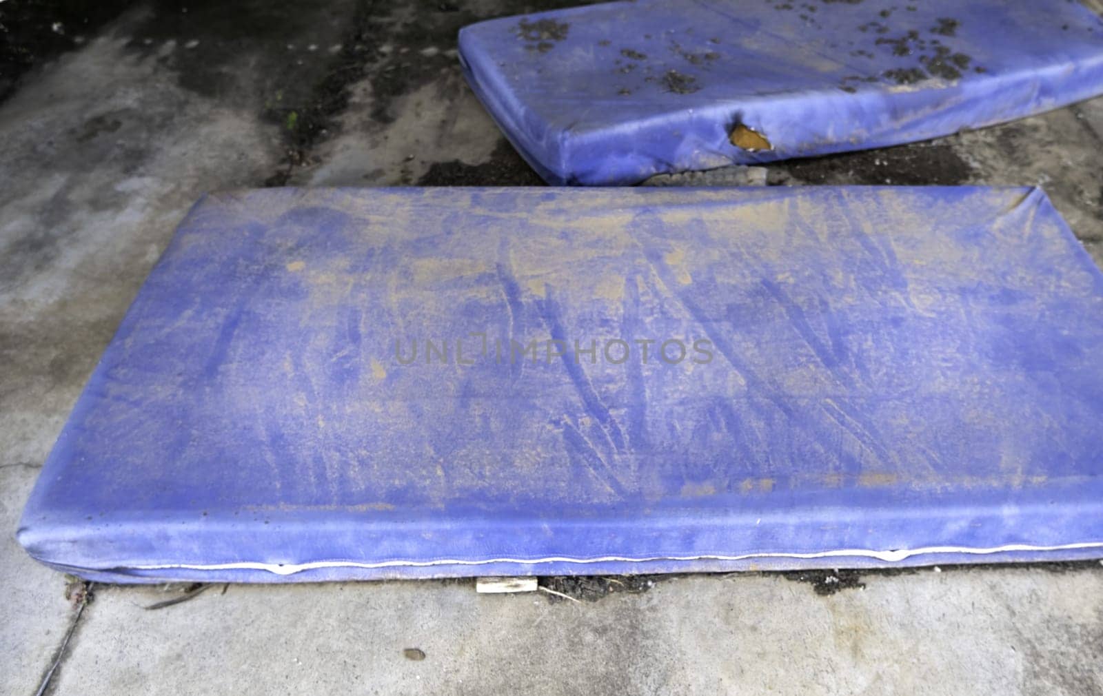 Detail of mattresses thrown in the trash, pollution