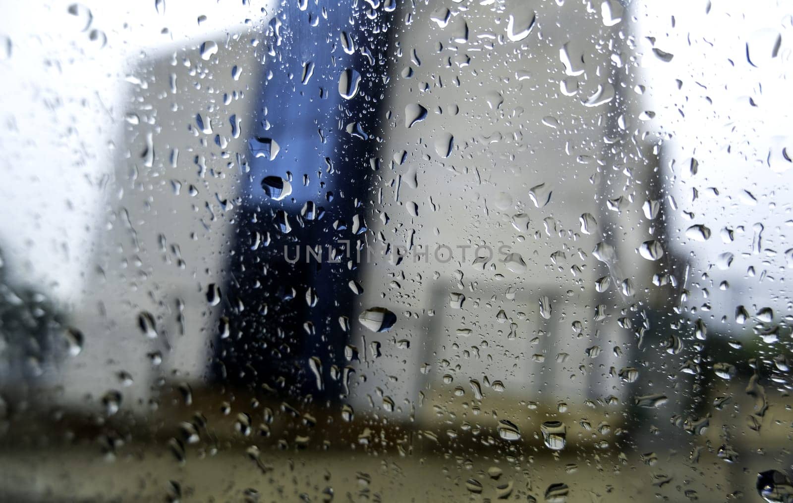 Detail of wet car window on cold winter rainy day