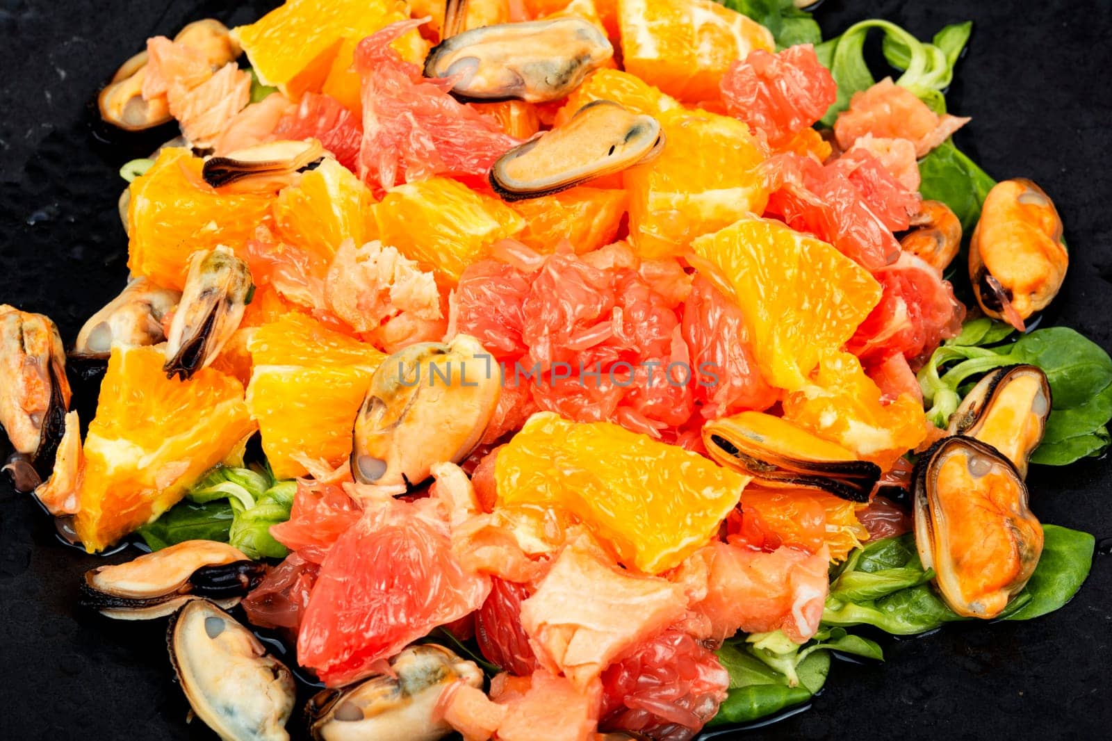 Seafood salad with grapefruit, orange and mussels. Top view, copy space.