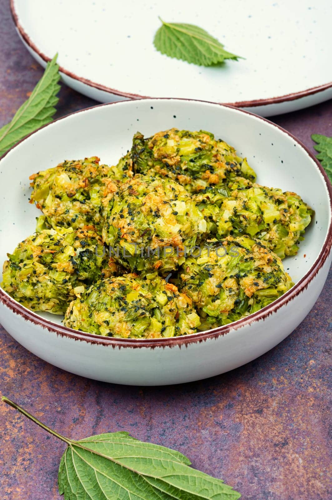 Baked green dietary cutlets made from young nettles. Vegetarian food. Space for text.