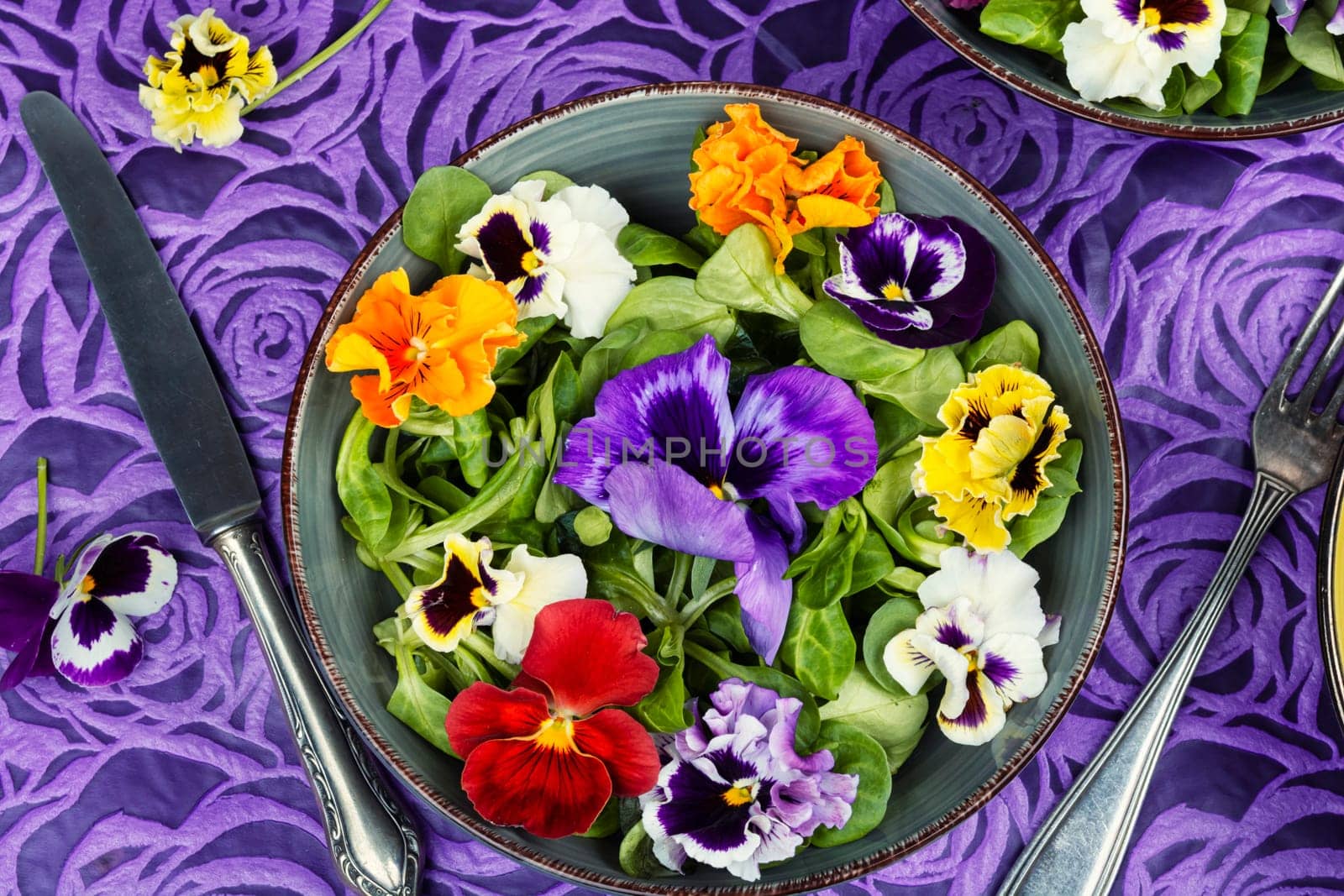 Symbolic colorful edible garden flower salad. Spring salad.