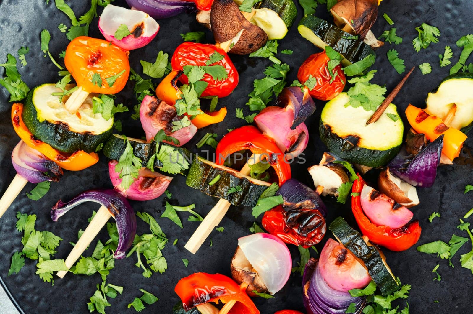 Vegan shashlik of fresh vegetables on wooden skewers. Copy space. Space for text.