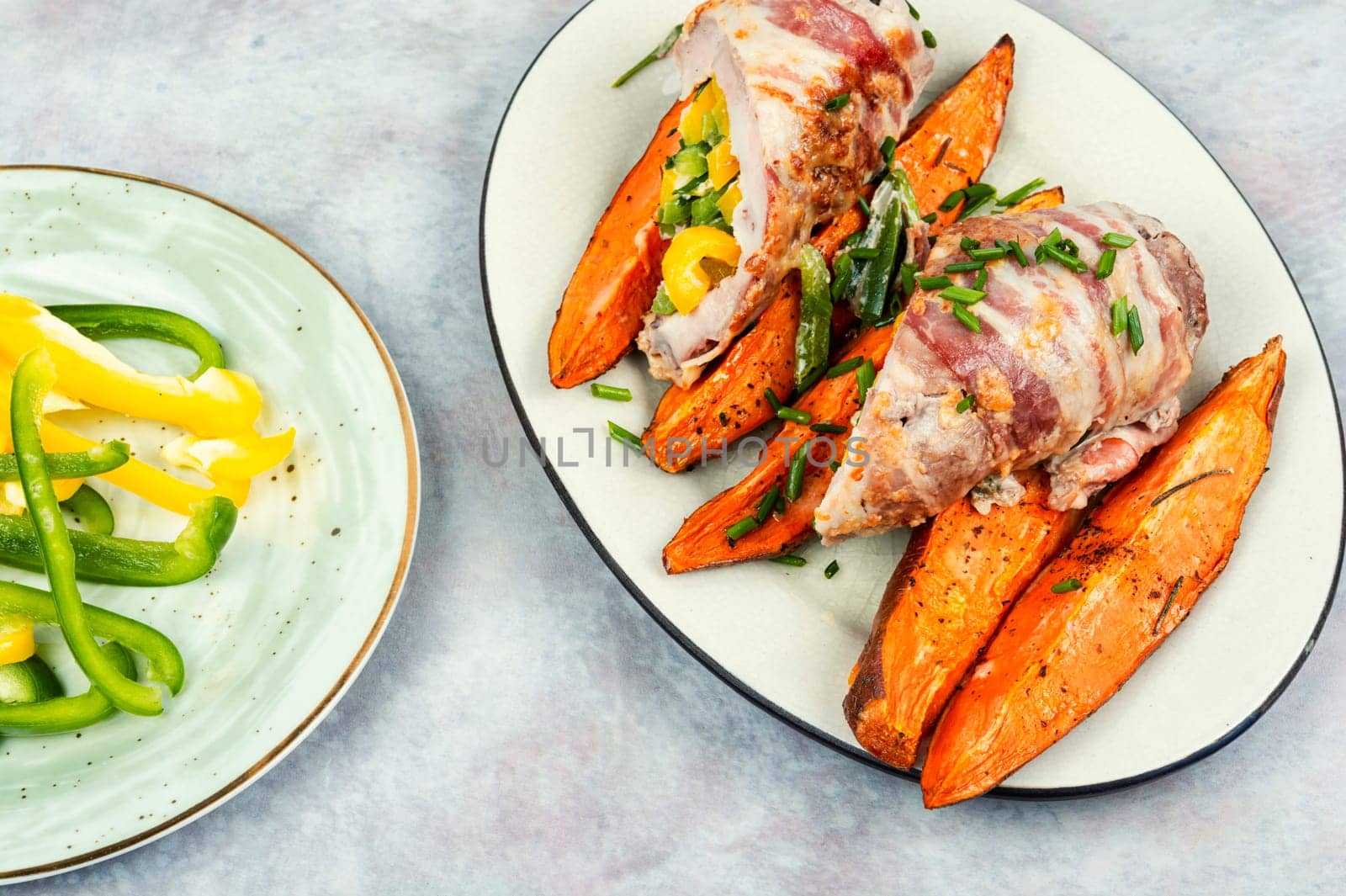 Roasted meat or meat roll, stuffed with peppers, bacon and baked sweet potatoes. Baked meat