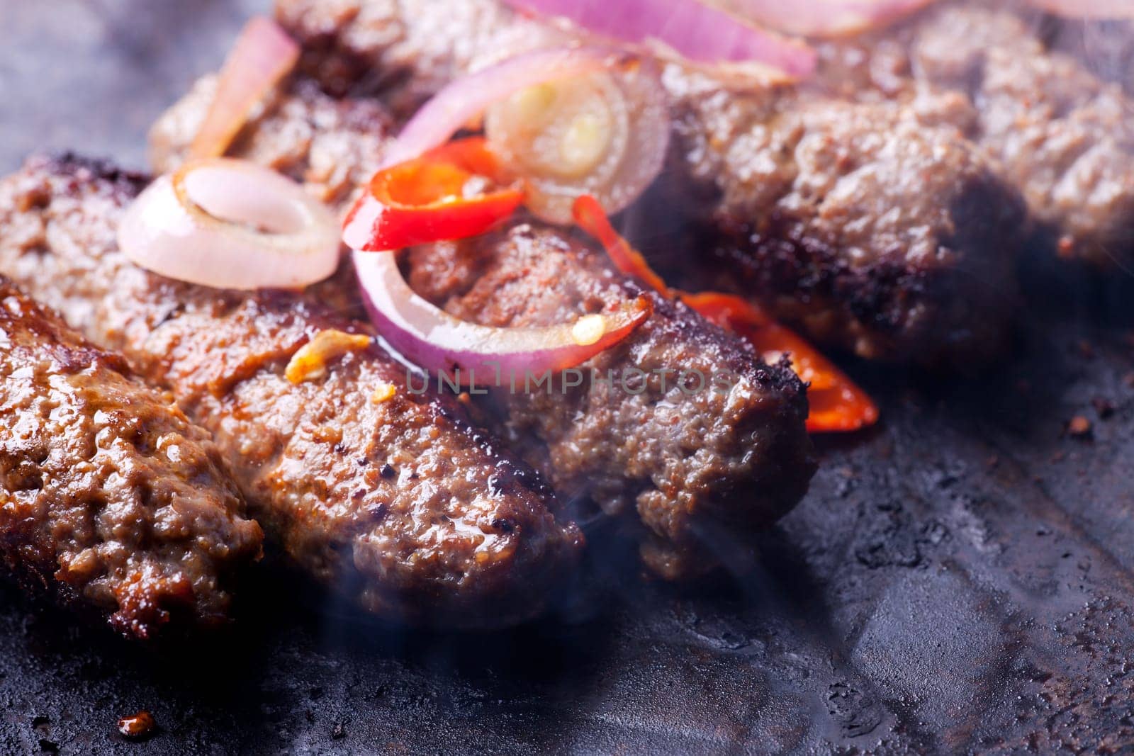 cevapcici minced meat rolls in a pan