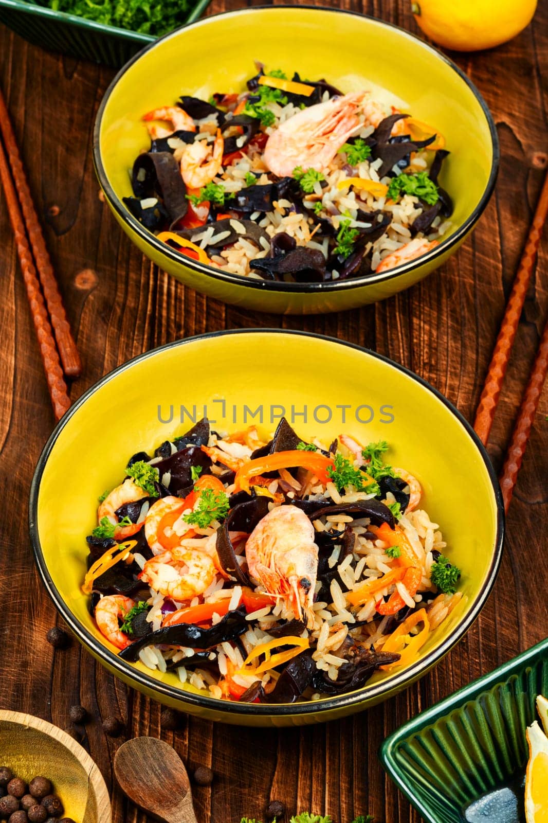 Thailand cuisine dish with rice, shrimps and vegetables on a vintage wooden background. Asian food style.