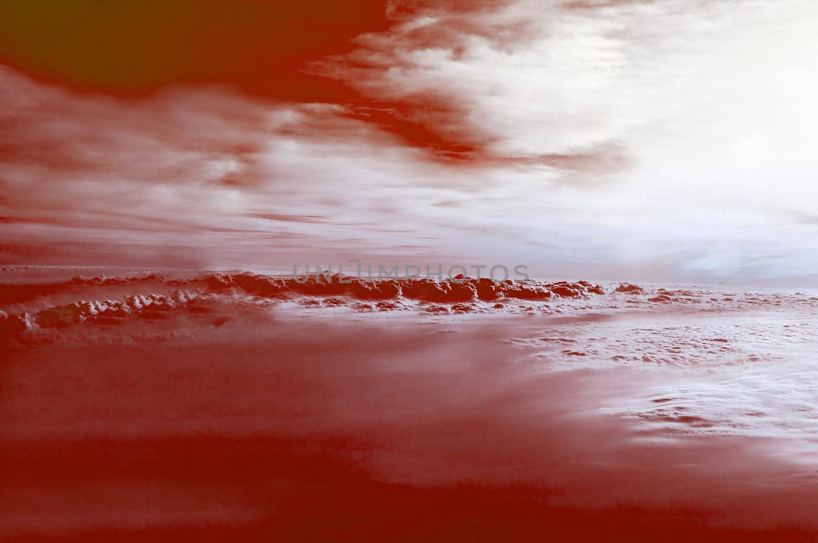 Red sunset sky with thick clouds from a bird's-eye view close-up