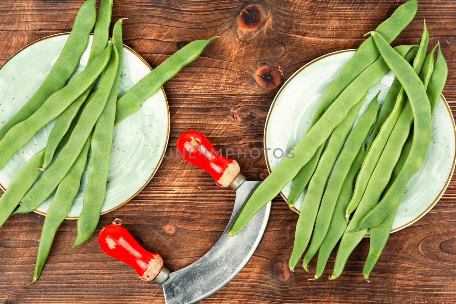 Raw runner beans, organic green beans on a rustic wooden table