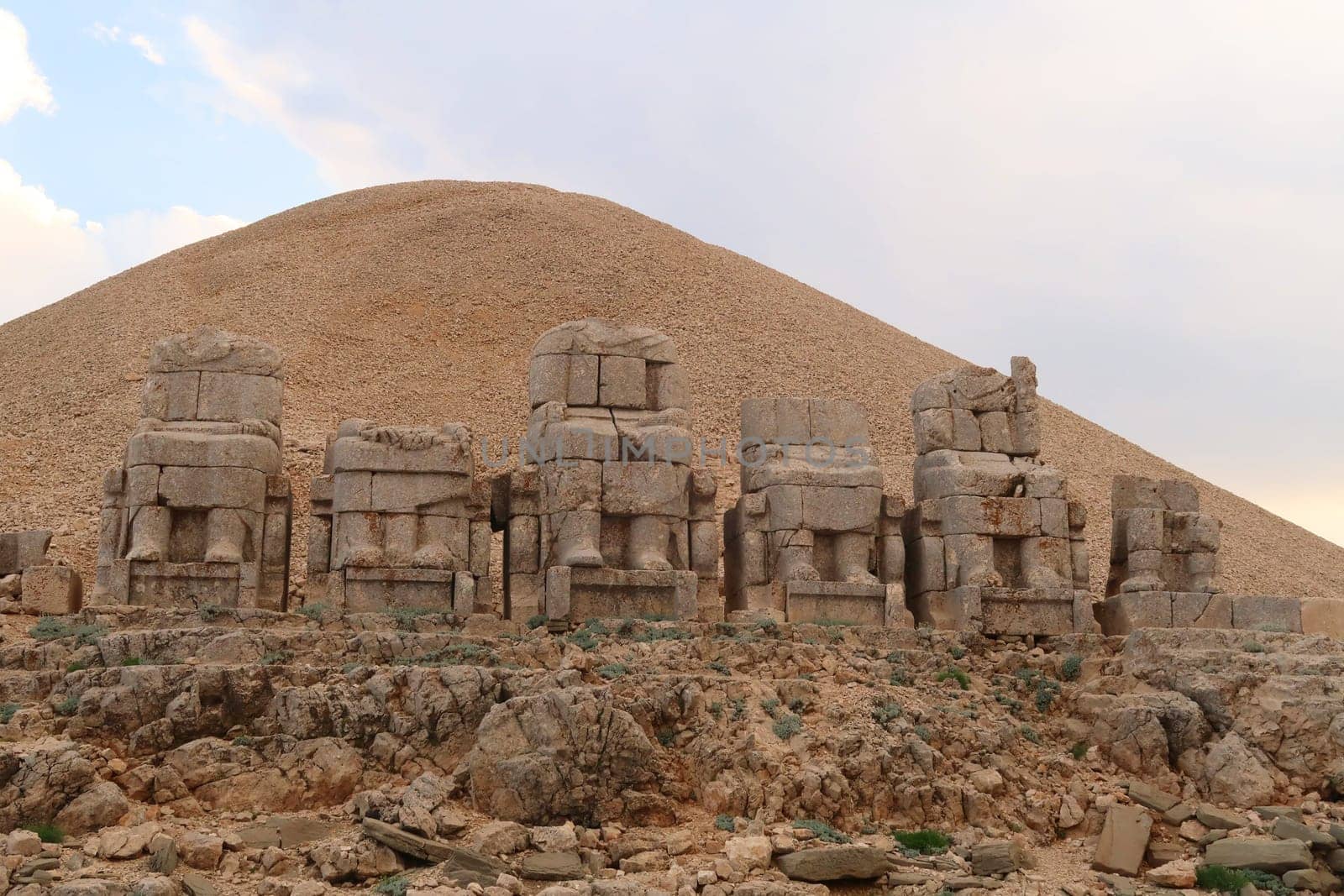 The majestic stone statues, sculptures on the East Terrace of Mount Nemrut, headless bodies of Antiochus, the Goddess of Commagene, Zeus, Apollon and Heracles sitting on thrones, close to Adiyaman, Turkey 2022