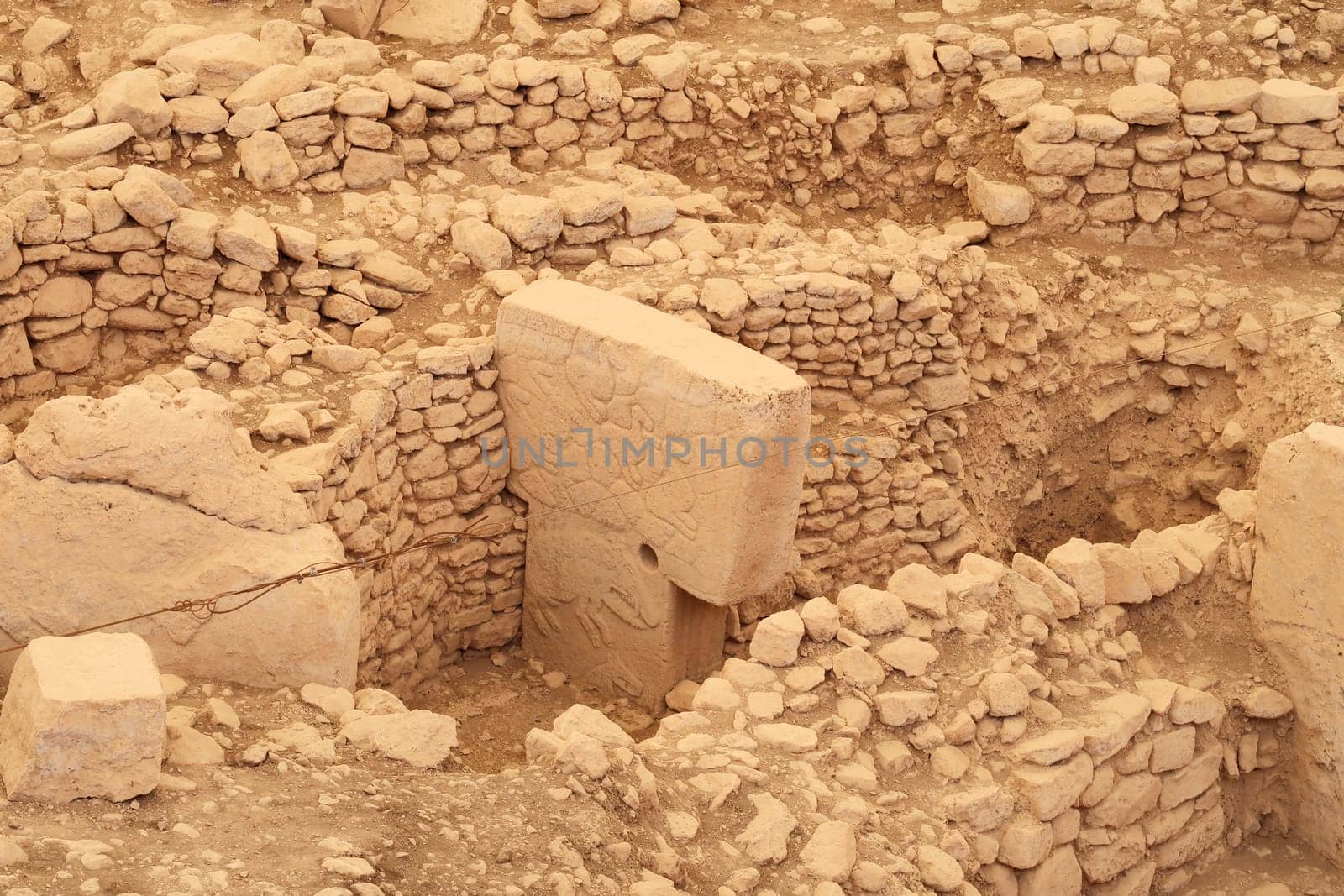 Pillar 12 in Enclosure C at the neolithic archaeological site of Göbekli Tepe, Potbelly Hill, a t-shaped pillar showing ducks and a boar, close to Sanliurfa, Turkey 2022