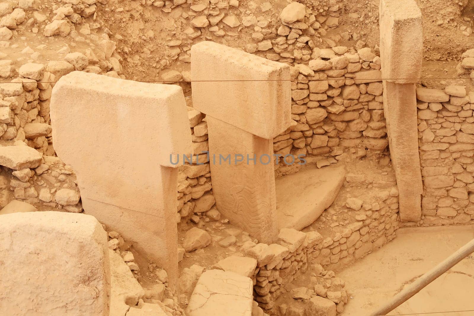A few of the pillars in enclosure D at the neolithic archaeological site of Göbekli Tepe, Potbelly Hill, Pillar 33 seen in the middle shows two cranes, close to Sanliurfa, Turkey 2022