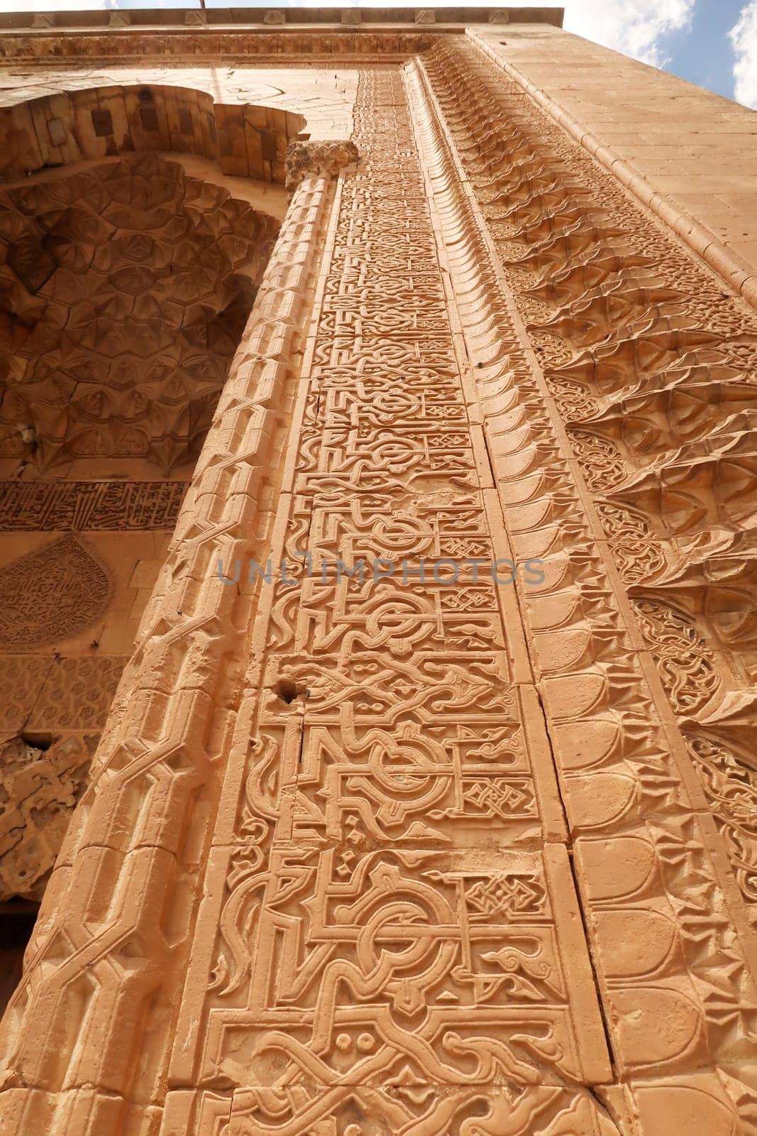 Elaborate carved patterns and details on the frame of the majestic gate of the Sultan Isa Medrese, Madrasa, Zinciriye Medrese in the old town of Mardin, Turkey 2022