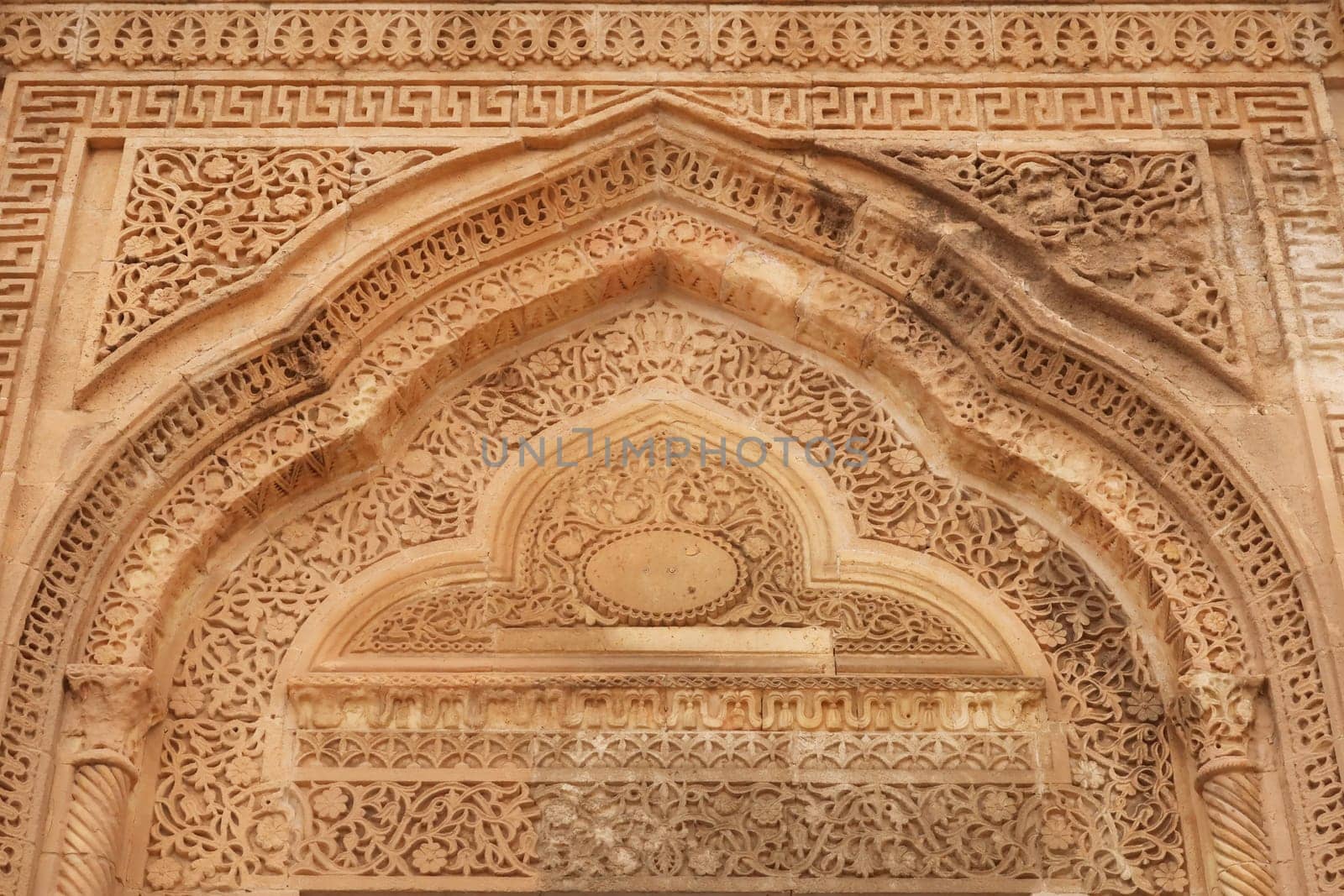 Elaborate carved patterns and details on top of the doorway of a traditional house in the old town of Mardin, Turkey 2022