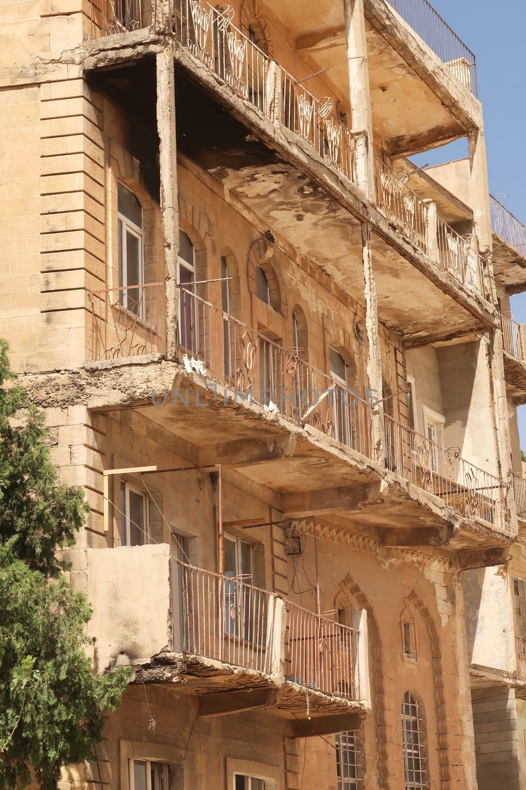 Elaborate traditional facade with many balconies on an apartment building in the old town of Mardin, Turkey 2022
