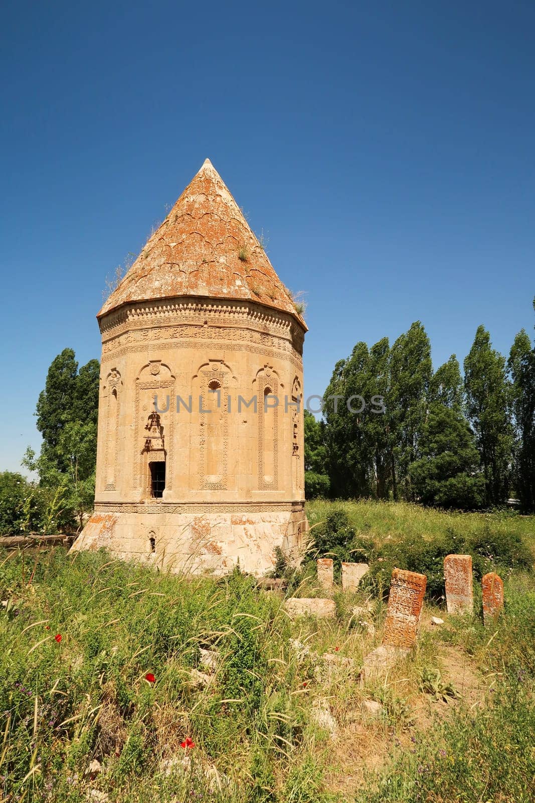 Overgrown little trail lined by tombstones leading to the Halime Hatun tomb, grave, mausoleum, Halime Hatun Kümbeti, close to Lake Van, Van Gölü, Gevas, Turkey 2022