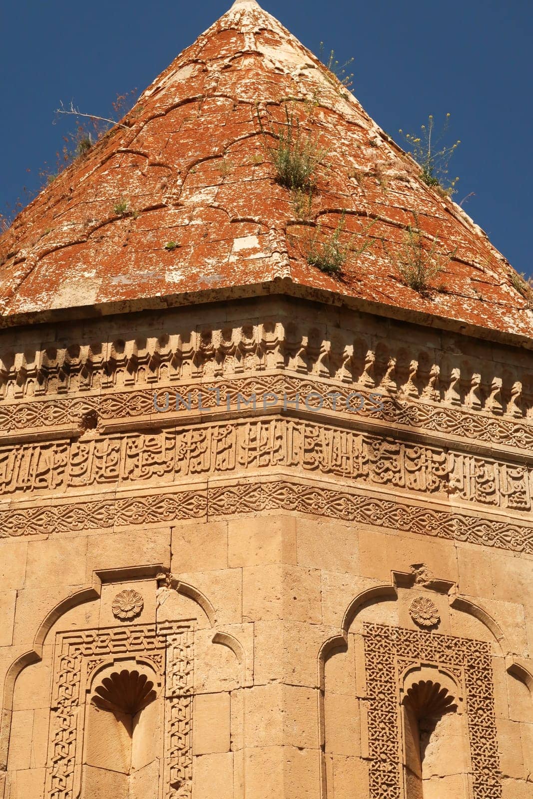 Closer look onto the facade and the roof of the Halime Hatun tomb, grave, mausoleum, Halime Hatun Kümbeti, elaborate patterns, details, carvings, close to Lake Van, Van Gölü, Gevas, Turkey 2022