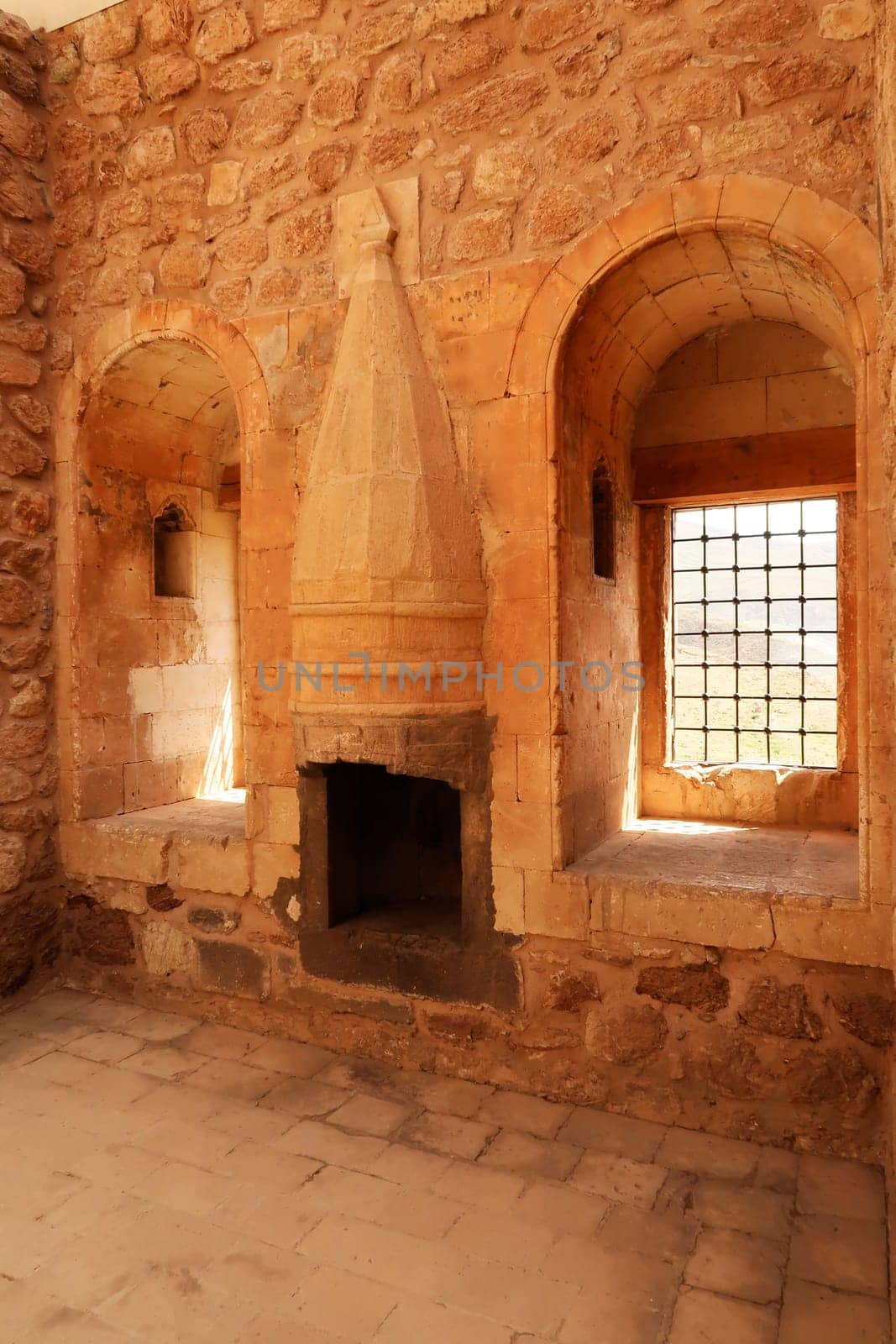 Room inside the ottoman Ishak Pasha Palace, Sarayi, barred windows and a traditiona chimney, Dogubeyazit, Turkey 2022