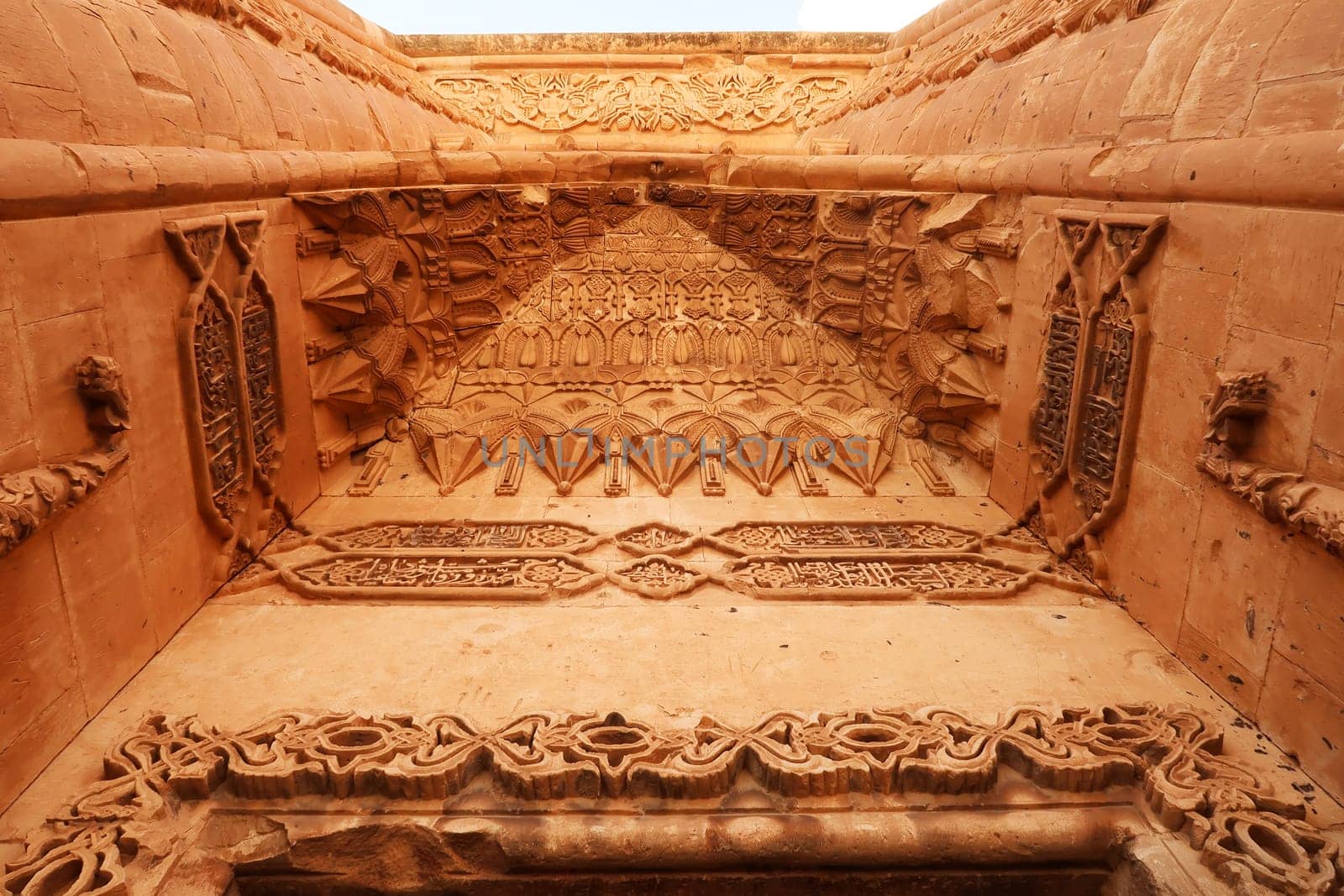 The elaborate patterns and details carved into the majestic ottoman gate, doorway seen from the second court inside the Ishak Pasha Palace, Sarayi, Dogubeyazit, Turkey 2022