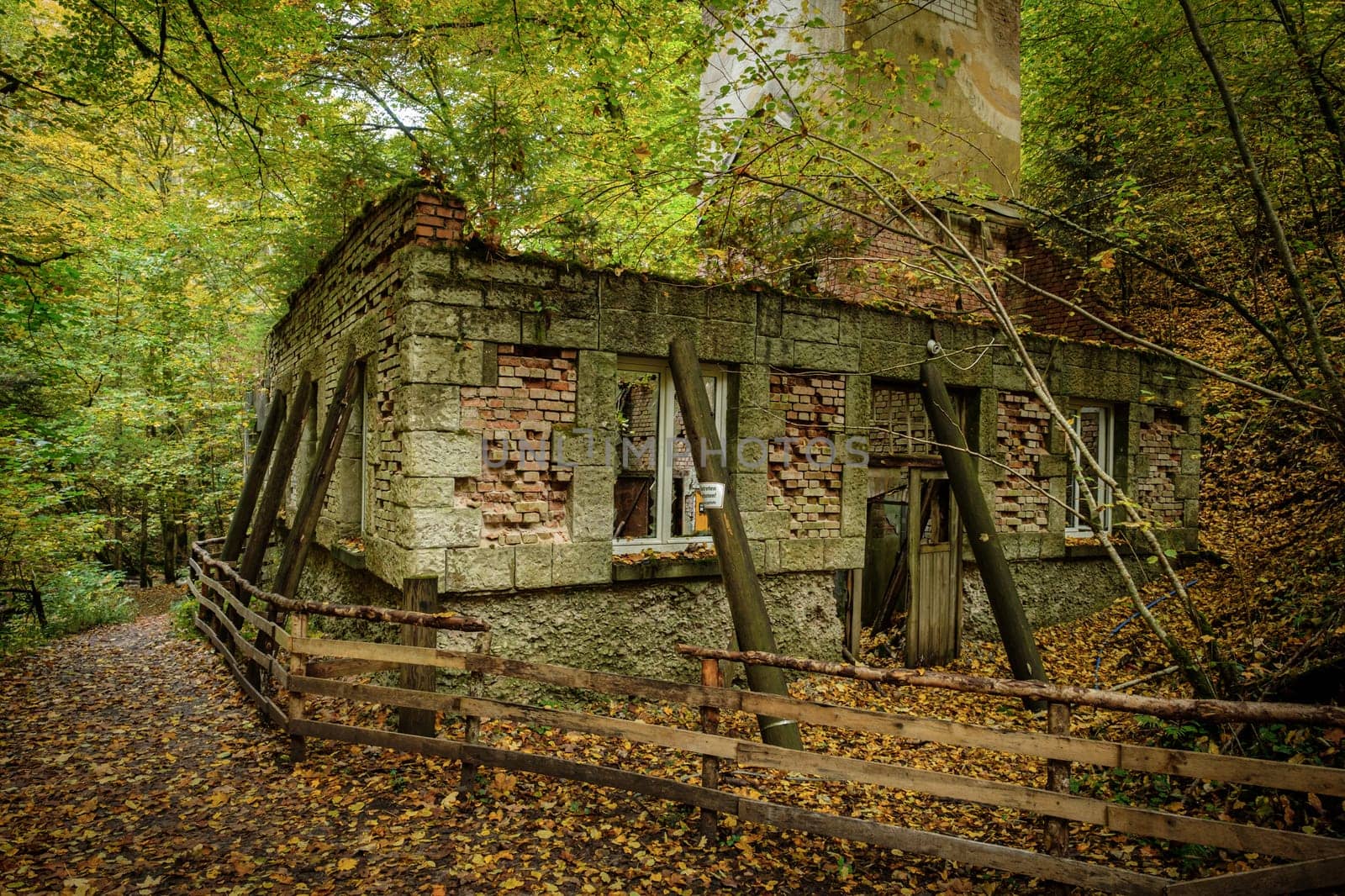 Old ruined industry building hydroelectric power plant station in fall
