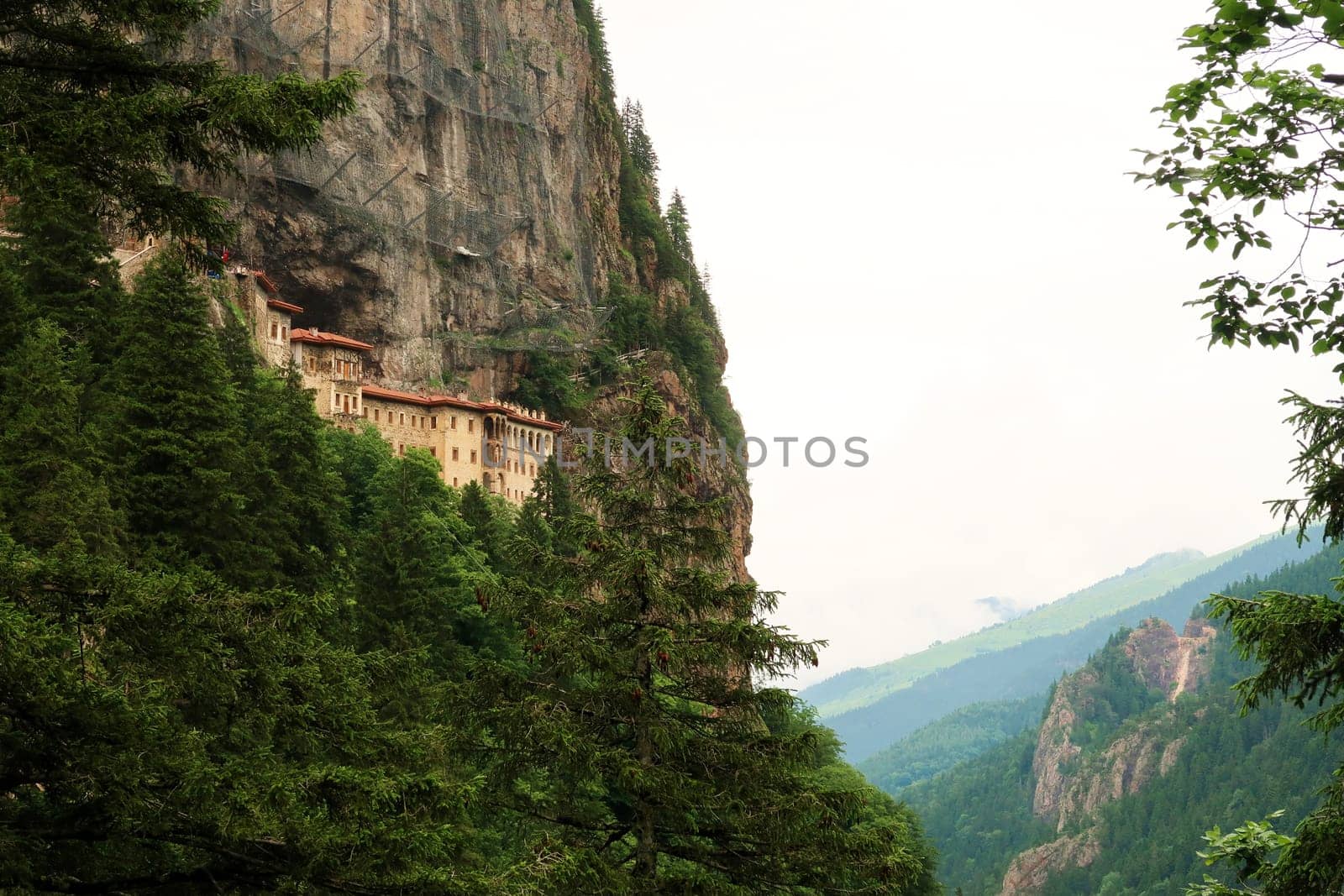 Picturesque view from the Aya Varvara Church, Kilisesi onto the Sumela, Sümela Monastery built on a cliff above a dense forest, Trabzon, Turkey 2022