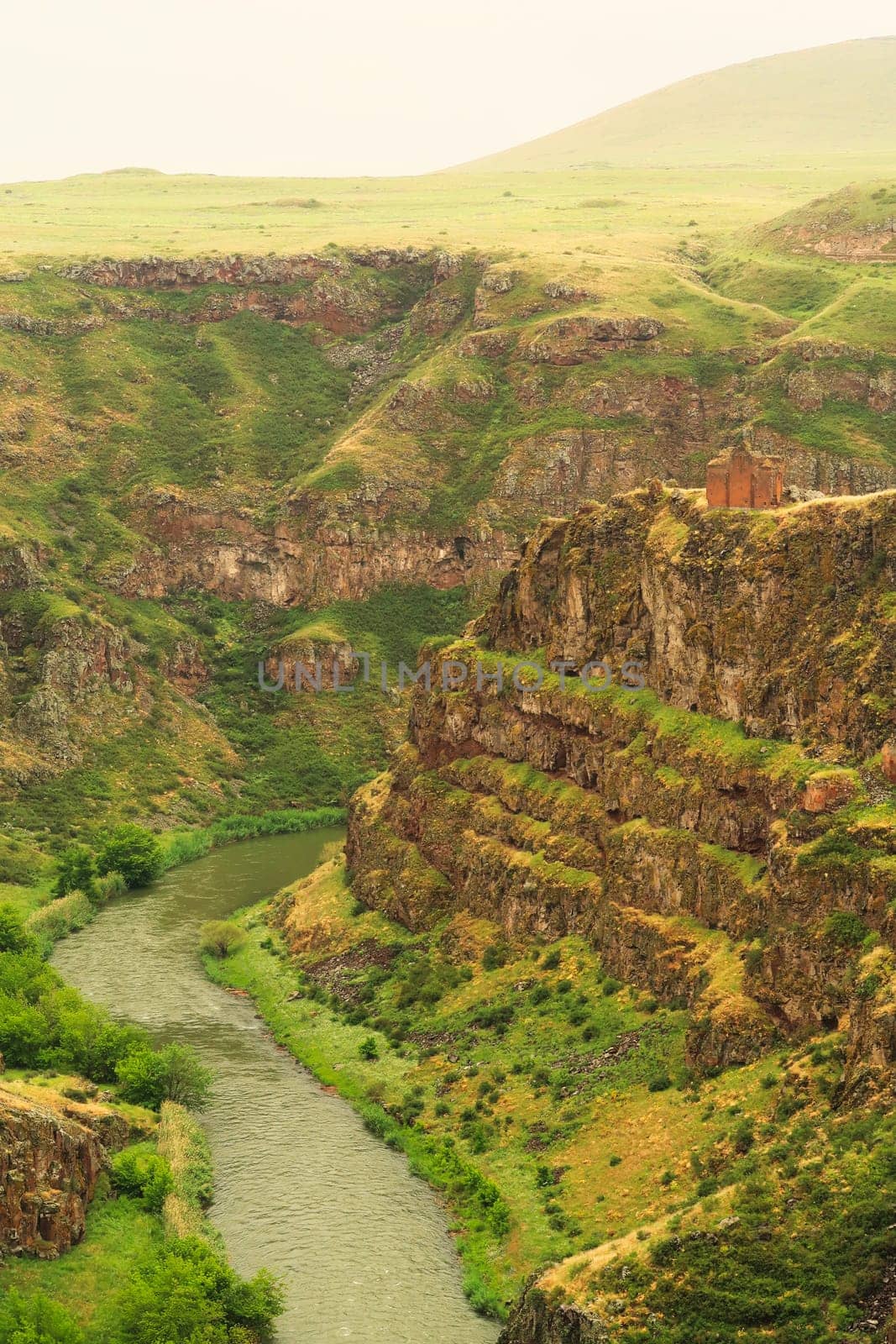Picturesque view on the promontory encircled by the canyon of the Akhurian River with the ruins of the Church of Saint Elia, Zakares Church on top, last remaining building of the Kizkale, Kiz Kalesi, Maidens, Virgins Castle, ancient site of Ani, Kars, Turkey 2022