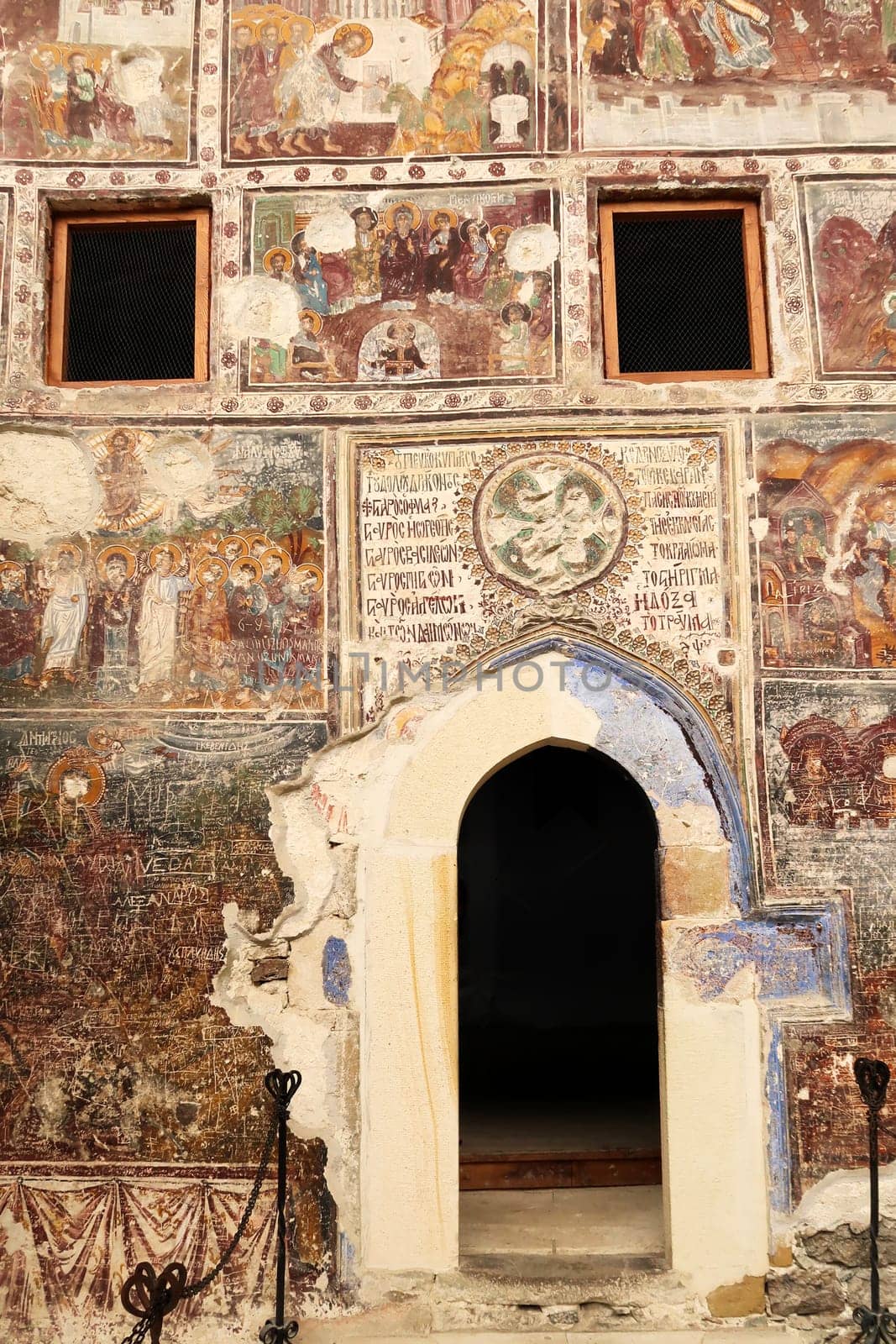 The entrance door to the Rock Church at the Sumela, Sümela Monastery, surrounded by colorful frescos, Trabzon, Turkey 2022