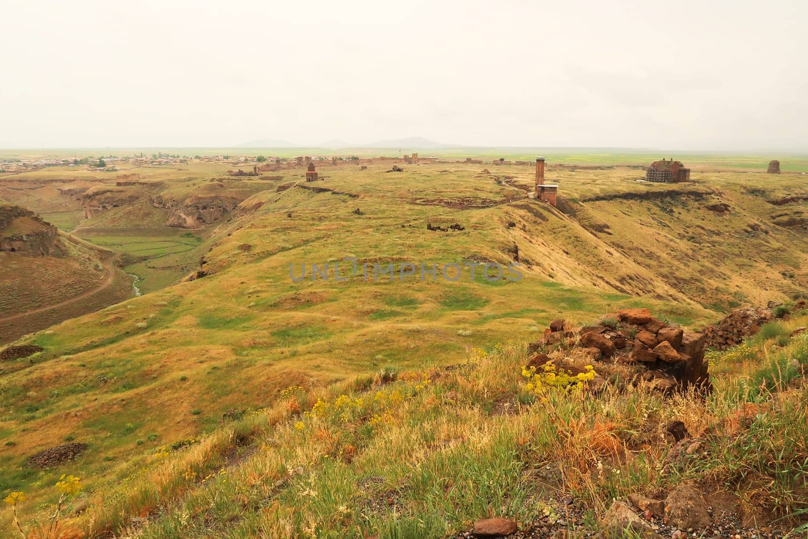 View from the Citadel onto the ancient site of Ani, an abandoned ruined armenian city, the Mosque of Minuchihr, the Cathedral, the Tigran Honents Church, the Church of St. Gregory and the city wall in the far distance can be seen, Kars, Turkey 2022