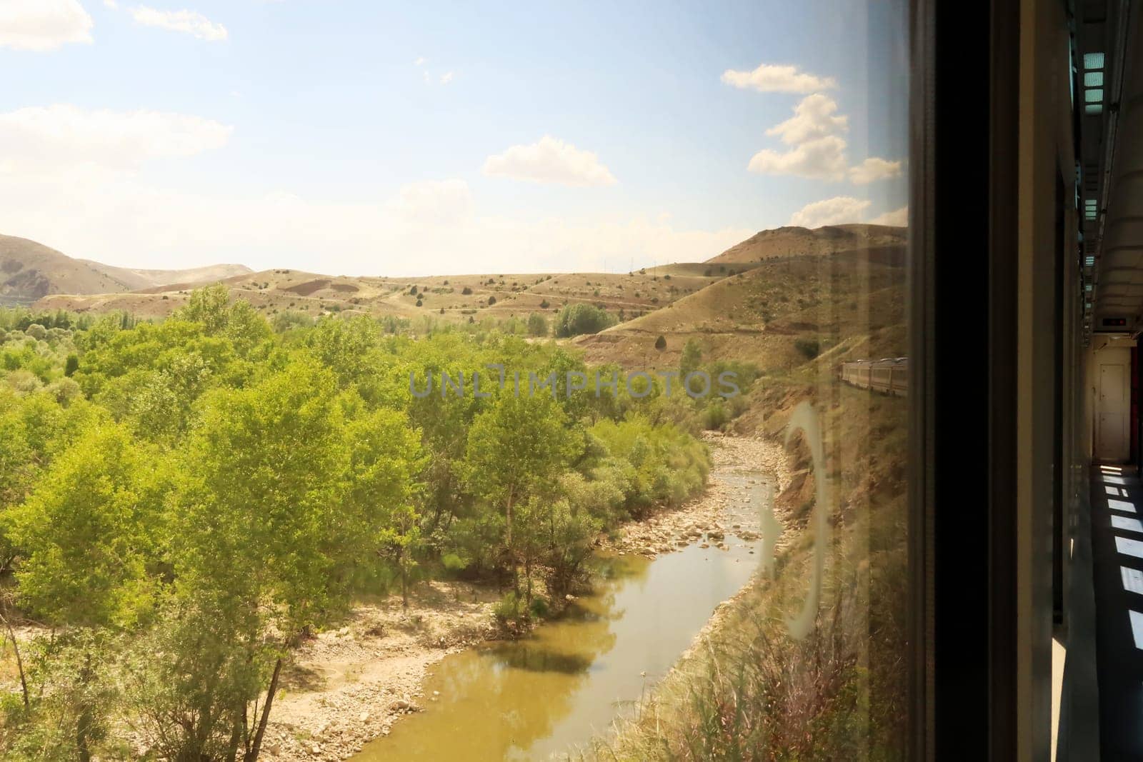 On the train ride in the Eastern Express, Dogu Ekspresi from Kars to Ankara, passing a river, the front of the train is visible, Turkey 2022
