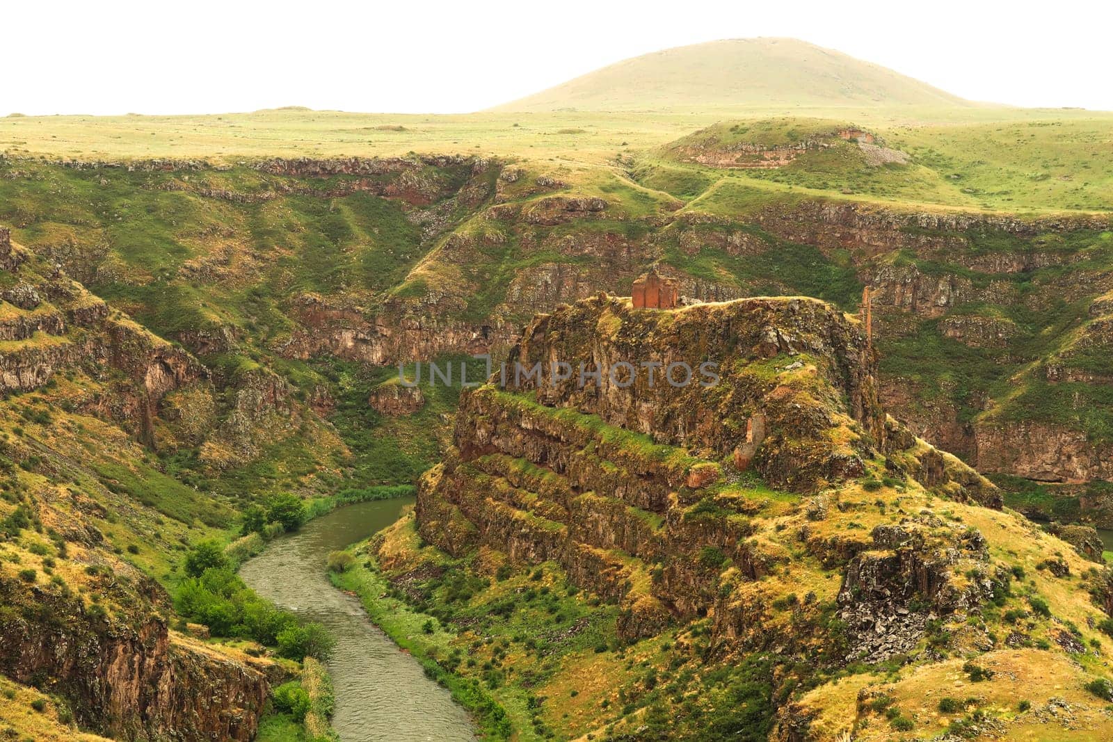 Spectacular view on the promontory encircled by the canyon of the Akhurian River with the ruins of the Church of Saint Elia, Zakares Church on top, last remaining building of the Kizkale, Kiz Kalesi, Maidens, Virgins Castle, ancient site of Ani, Kars, Turkey 2022
