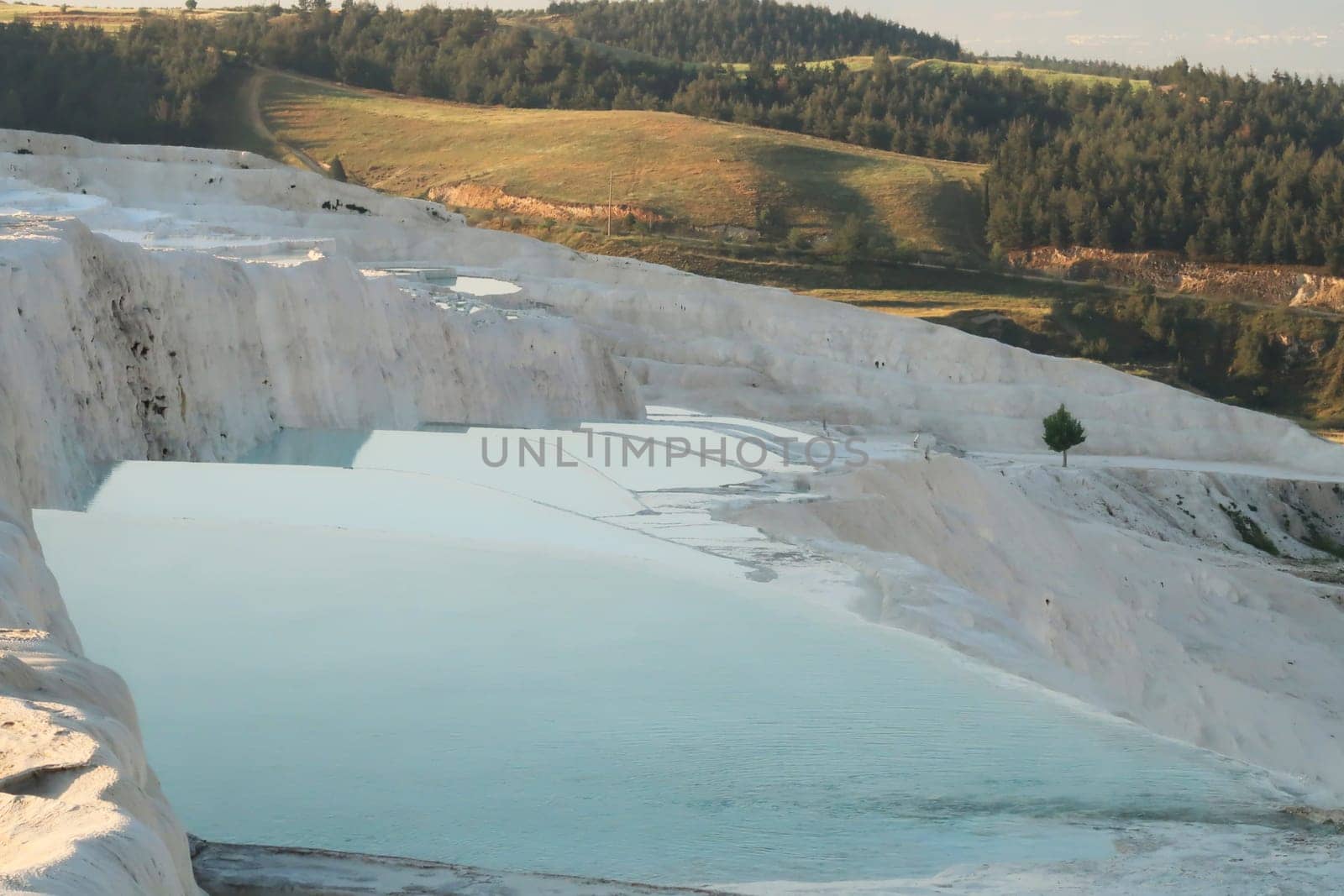 Turquoise blue water in the travertines of Pamukkale early in the morning, Denizli, Turkey 2022