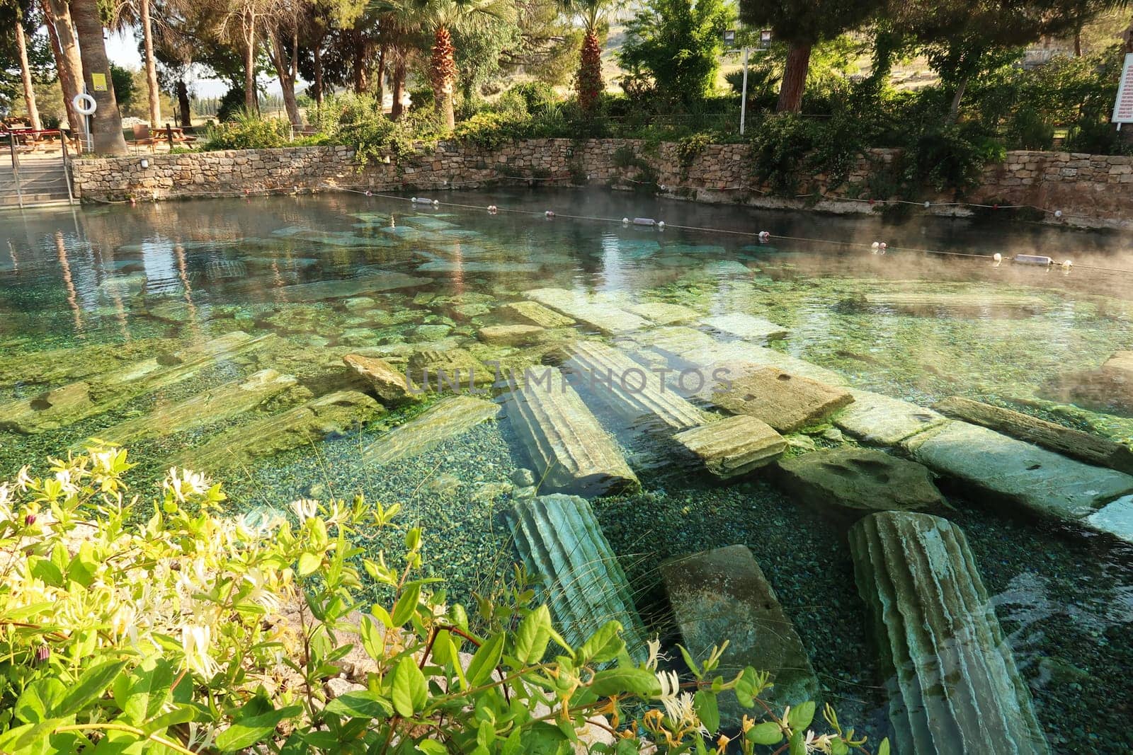 The picturesque Cleopatra Pool, hot spring with submerged roman columns inside in the early morning, Denizli, Turkey 2022
