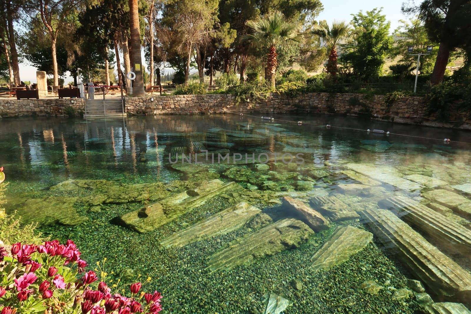 The famous Cleopatra Pool in the early morning, hot spring with submerged roman columns inside, Denizli, Turkey 2022