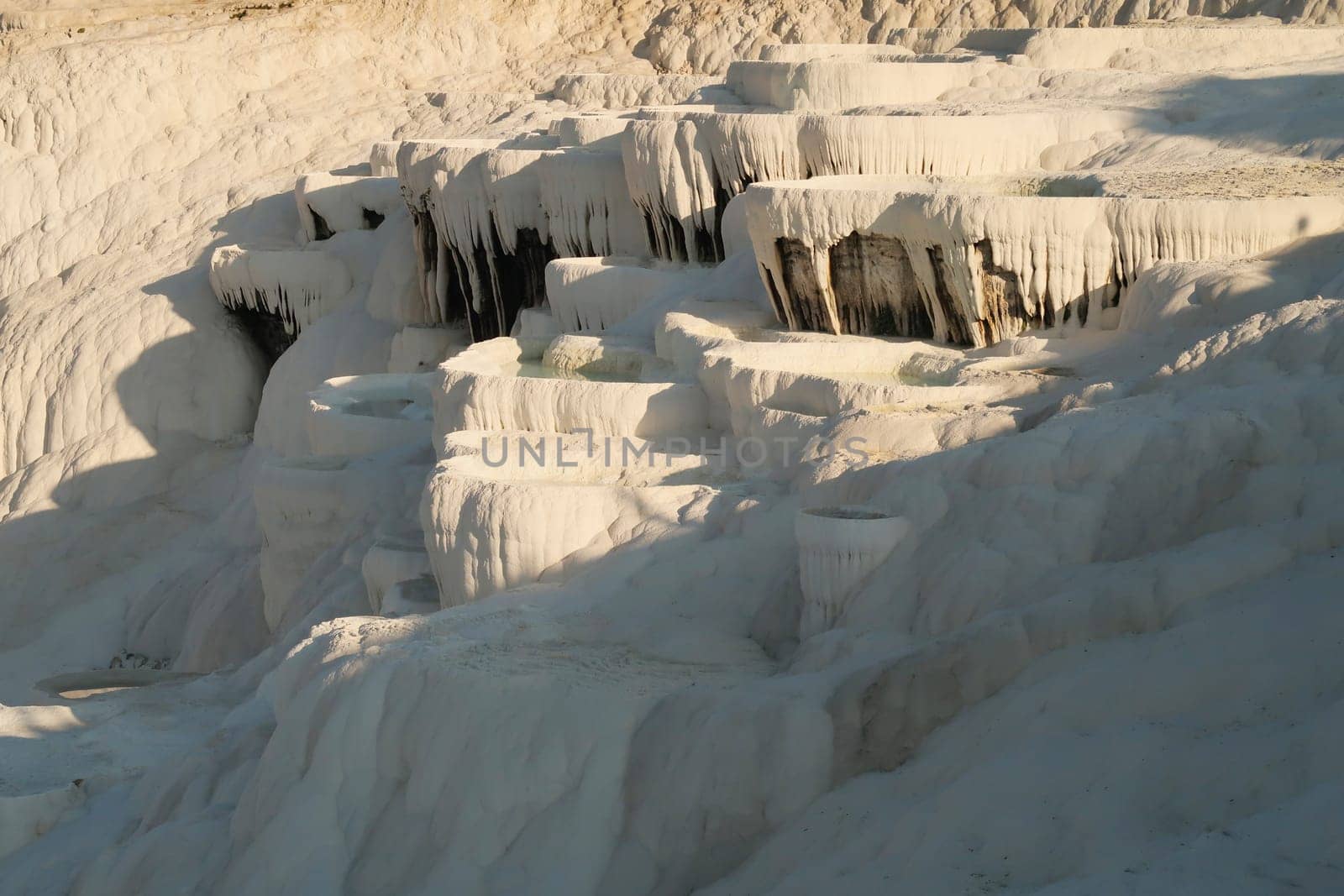 The many layers of travertine terraces at Pamukkale early in the morning, Denizli, Turkey 2022