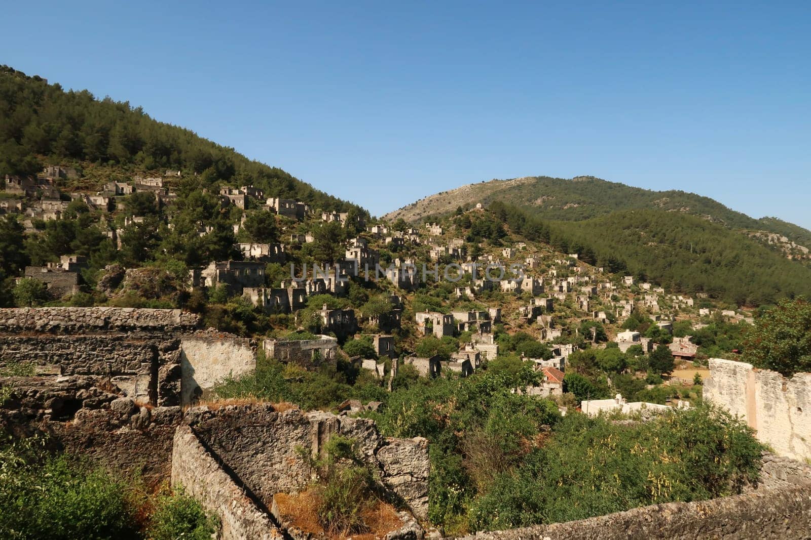 Ruins of houses in the abandoned village of Kayaköy, Livissi, close to Fethiye, Turkey 2022