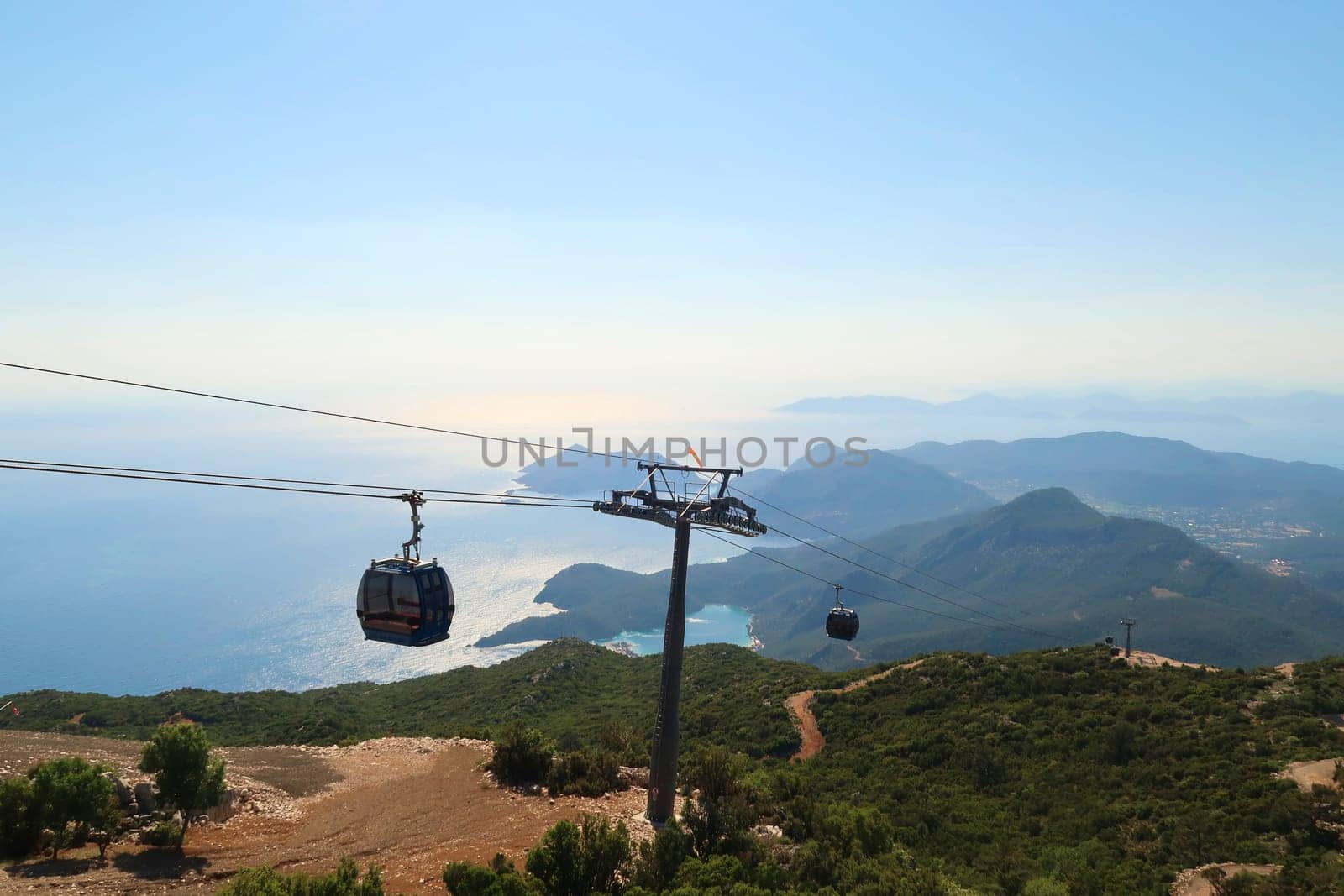 Spectacular view from the Babadag Mountain onto the coastline of Ölüdeniz with the cable car in the foreground, Ölüdeniz, Turkey 2022