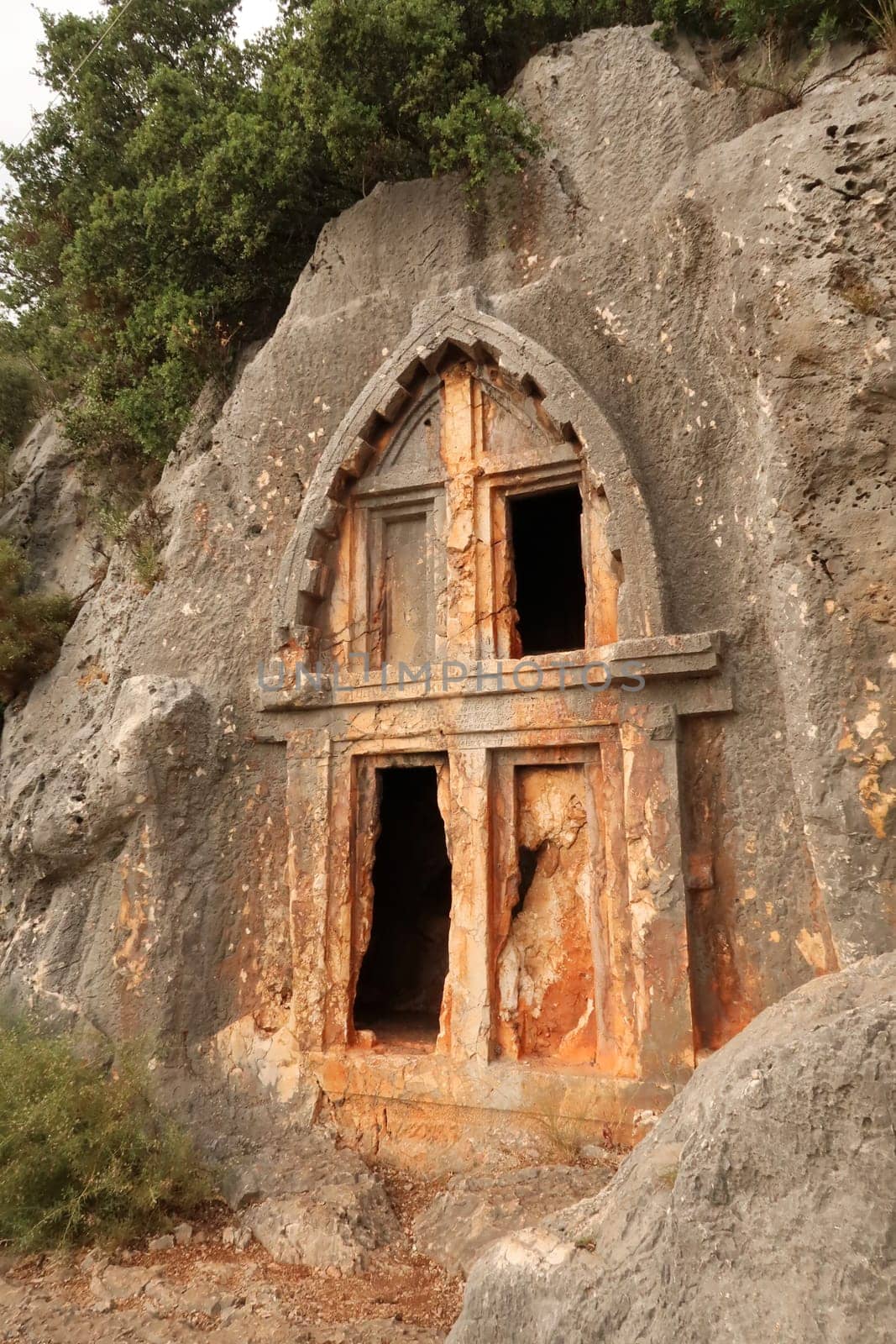 Ancient Lycian rock hewn, rock cut tomb above the coastal town of Kas, Turkey 2022