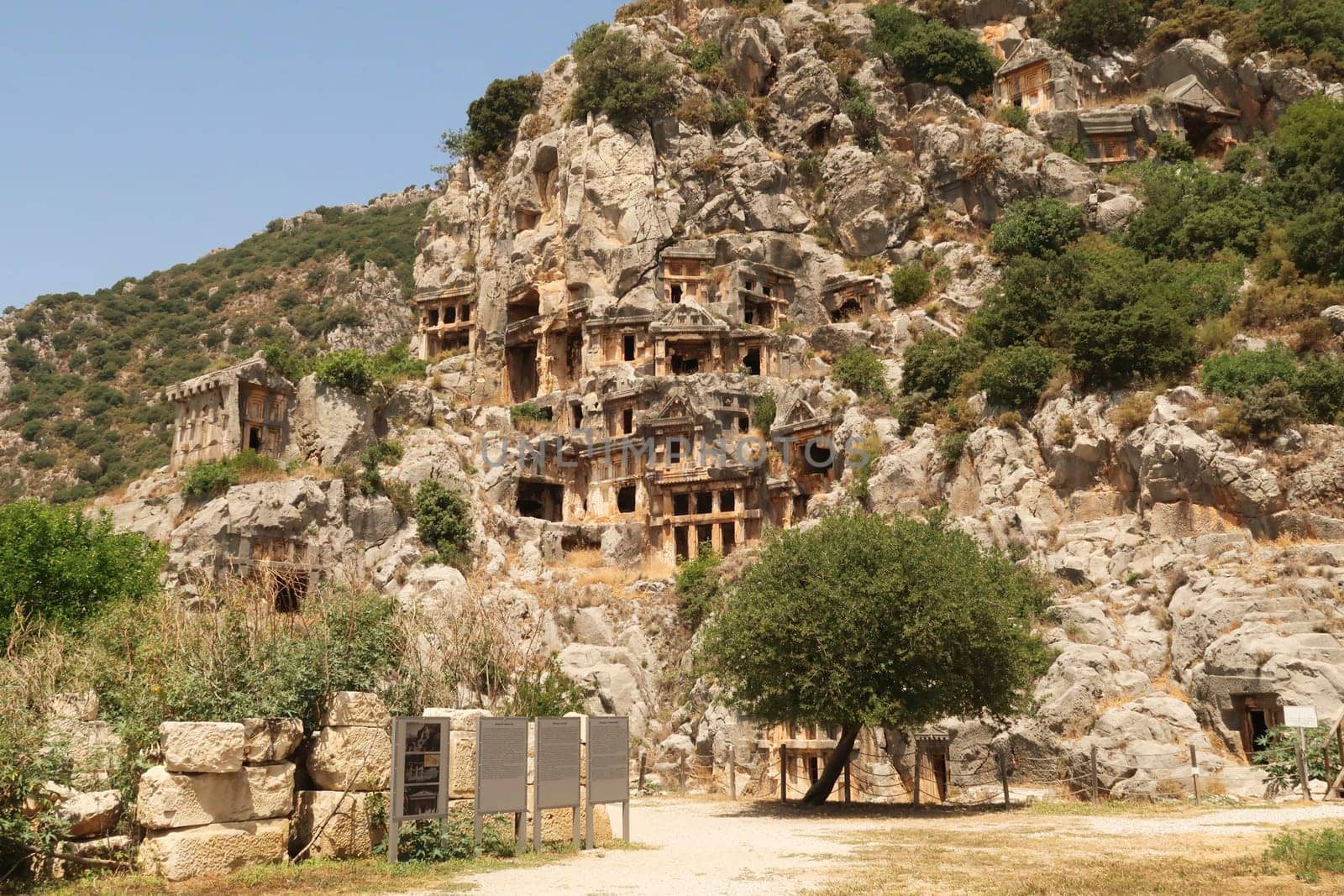 The archaeological site of Myra with its famous rock hewn, rock cut tombs on the cliff in the background, close to Demre, Turkey 2022