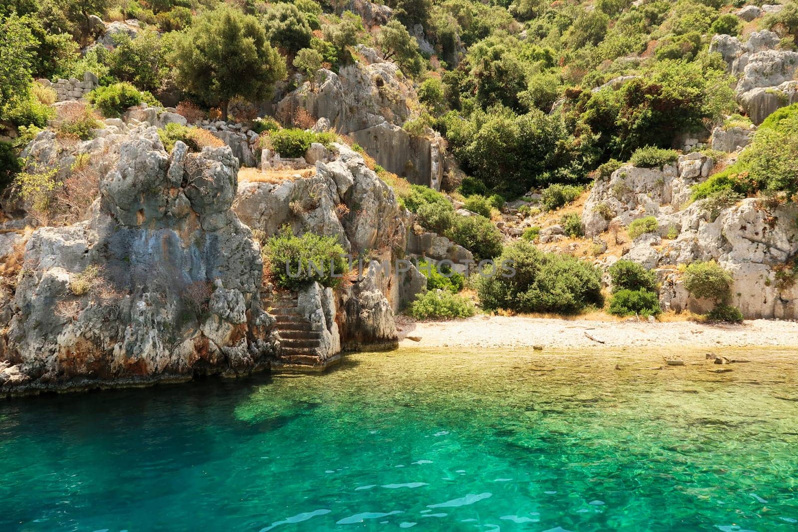 Remaining stairs leading into the water at the ancient sunken city of Kekova, Kekova Island, Demre, Turkey 2022