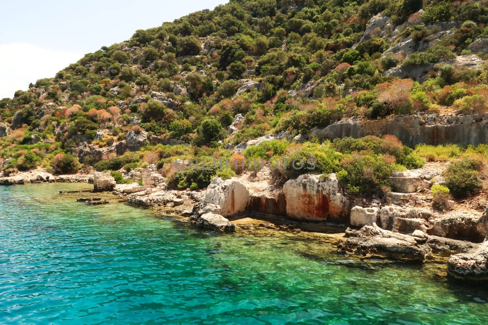 Remaining structures and walls of the ancient sunken city of Kekova on the shore of Kekova Island, Demre, Turkey 2022