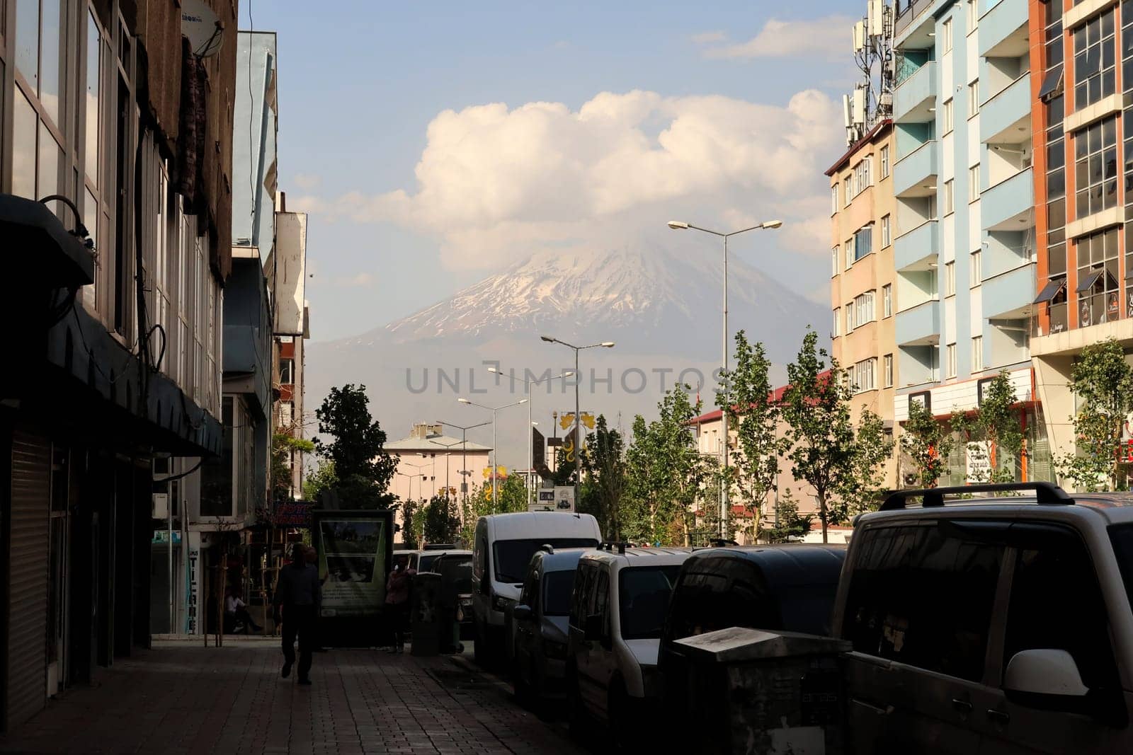 Mount Ararat seen from the city center of Dogubeyazit, its peak is covered in snow and clouds, Dogubeyazit, Turkey, 19th of June 2022