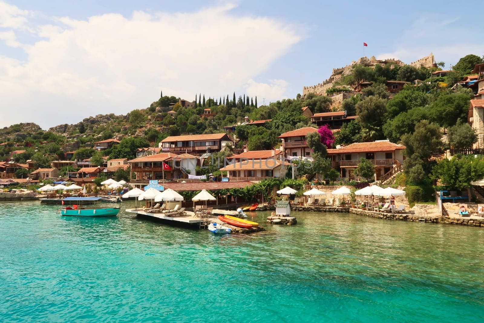 The picturesque coastal town of Kaleköy, ancient town of Simena seen from the boat on our Kekova Island Tour, near Demre, Turkey, 27th of May 2022