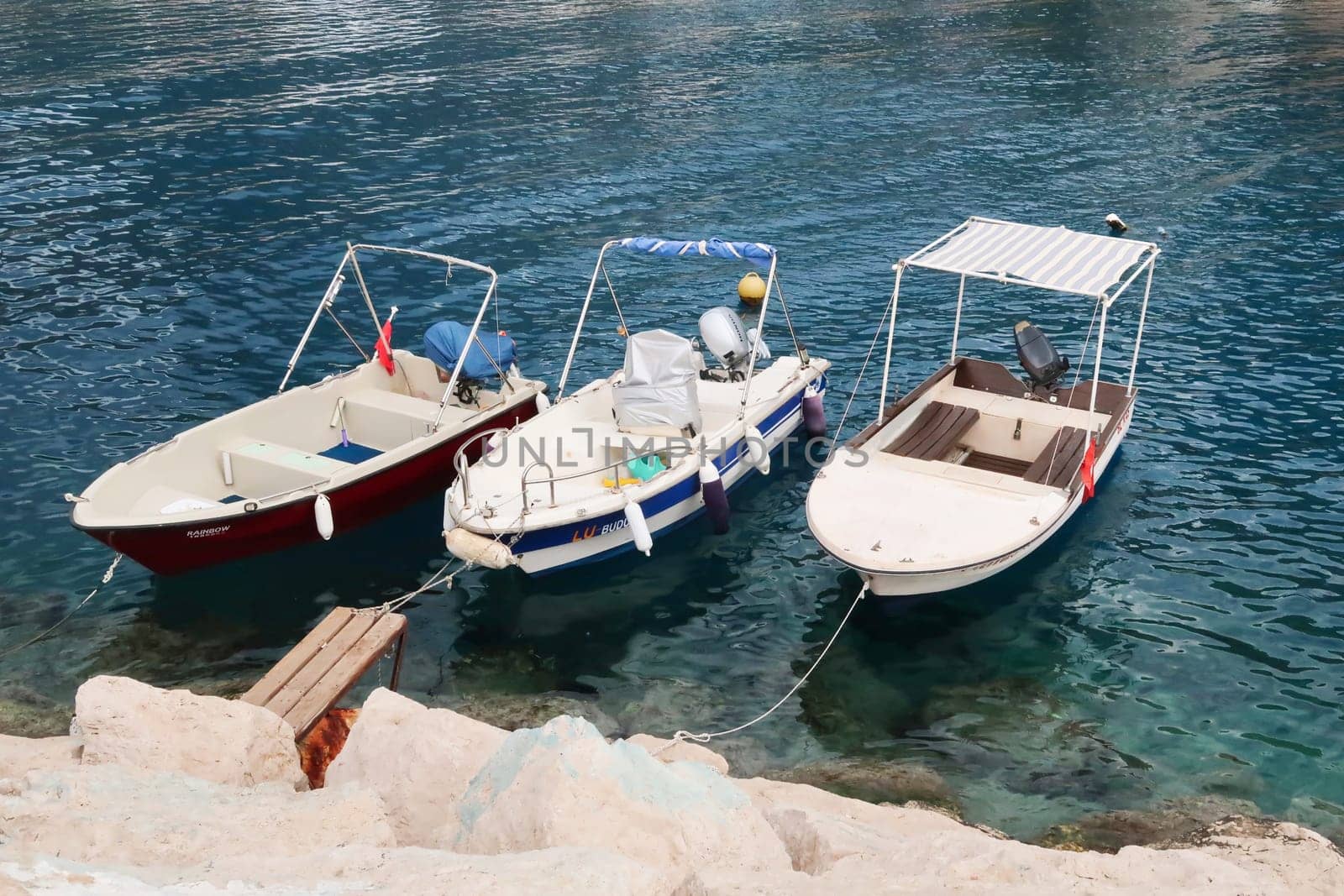 Three boats tied up in the harbour of Kas, Turkey, 26th of May 2022