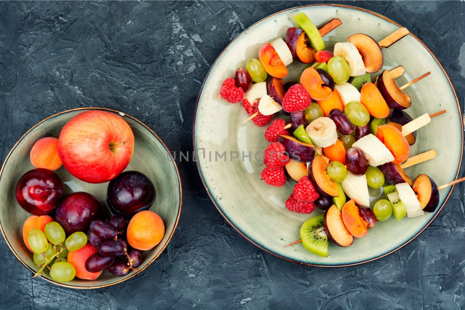 Colorful fruit skewers made from fresh fruits on wooden skewers.