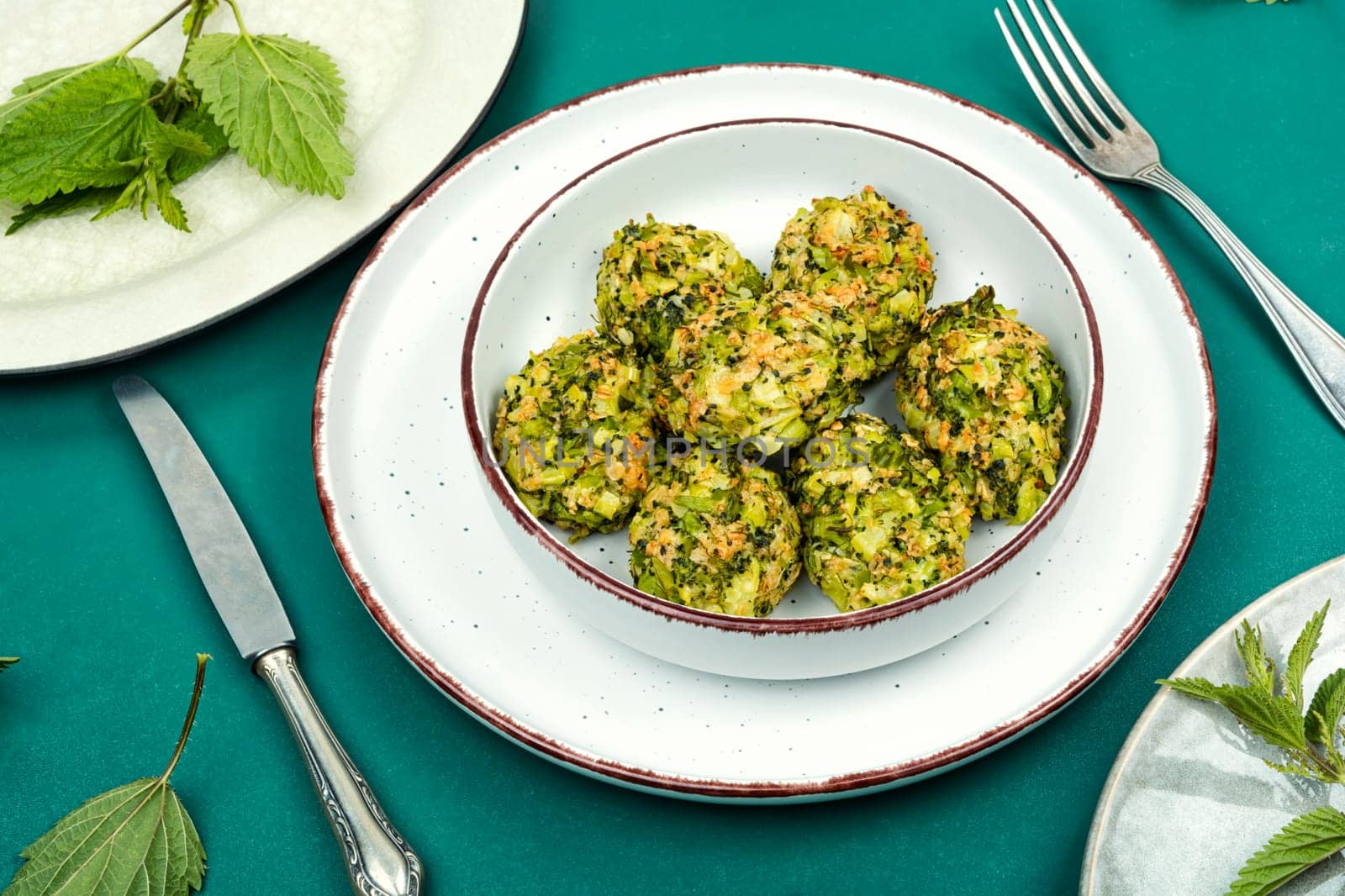 Homemade green dietary cutlets or meatballs made from young nettles. Vegetarian food. Flat lay.