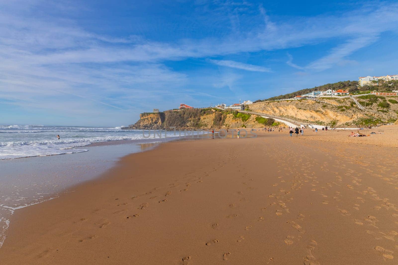 Sintra, Portugal: February 17, 2024: People at the beach of Magoito in a winter day, Sintra, Portugal