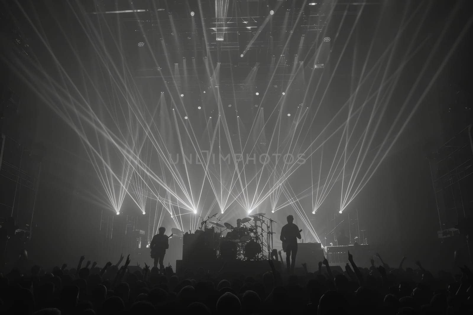 A group of people stands on top of a stage, bathed in a warm, glowing light, creating a vibrant and dynamic atmosphere.