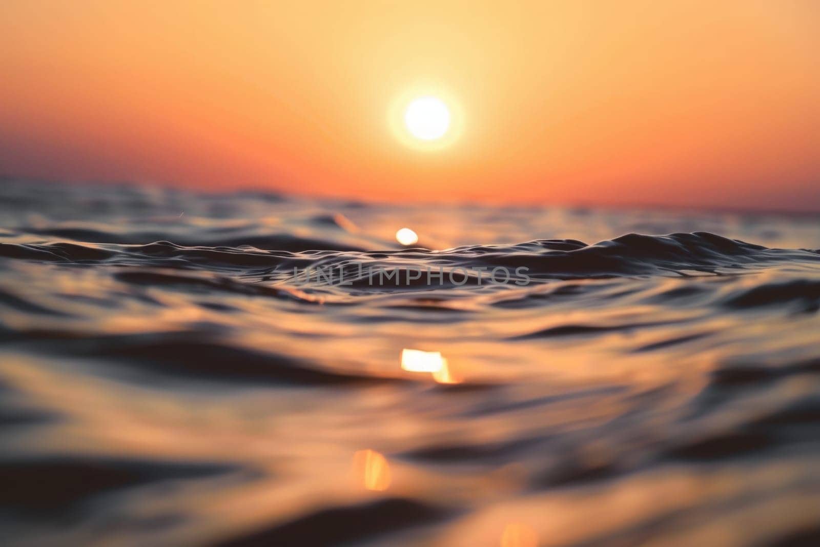 The sun gracefully sinks into the horizon, casting a warm golden glow over the tranquil ocean waters.