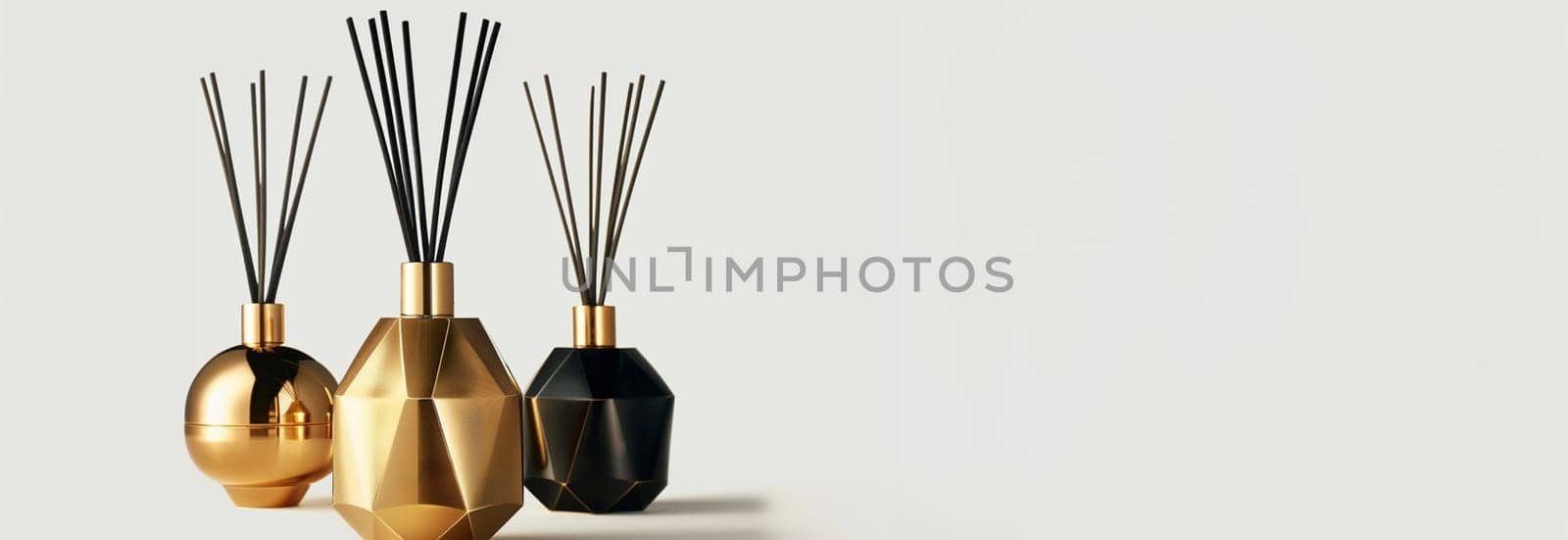 Home perfume in glass bottle with wood sticks, scented burn candles on tray in bedroom living room close up over white. Aromatherapy cozy atmosphere lifestyle. Winter warm xmas season. Good morning. elegant